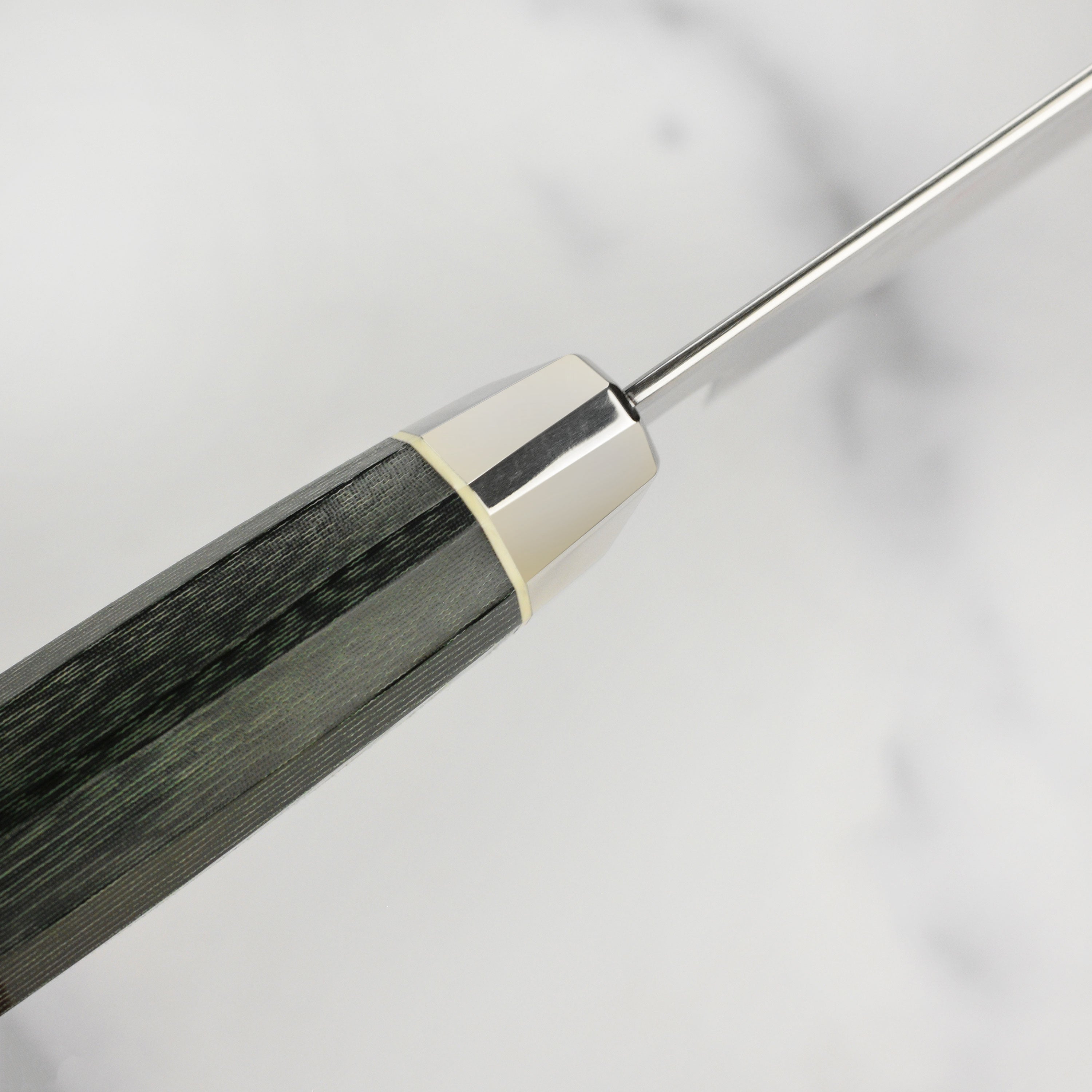 The Zanmai Revolution knife in action, expertly slicing vegetables on a wooden surface.