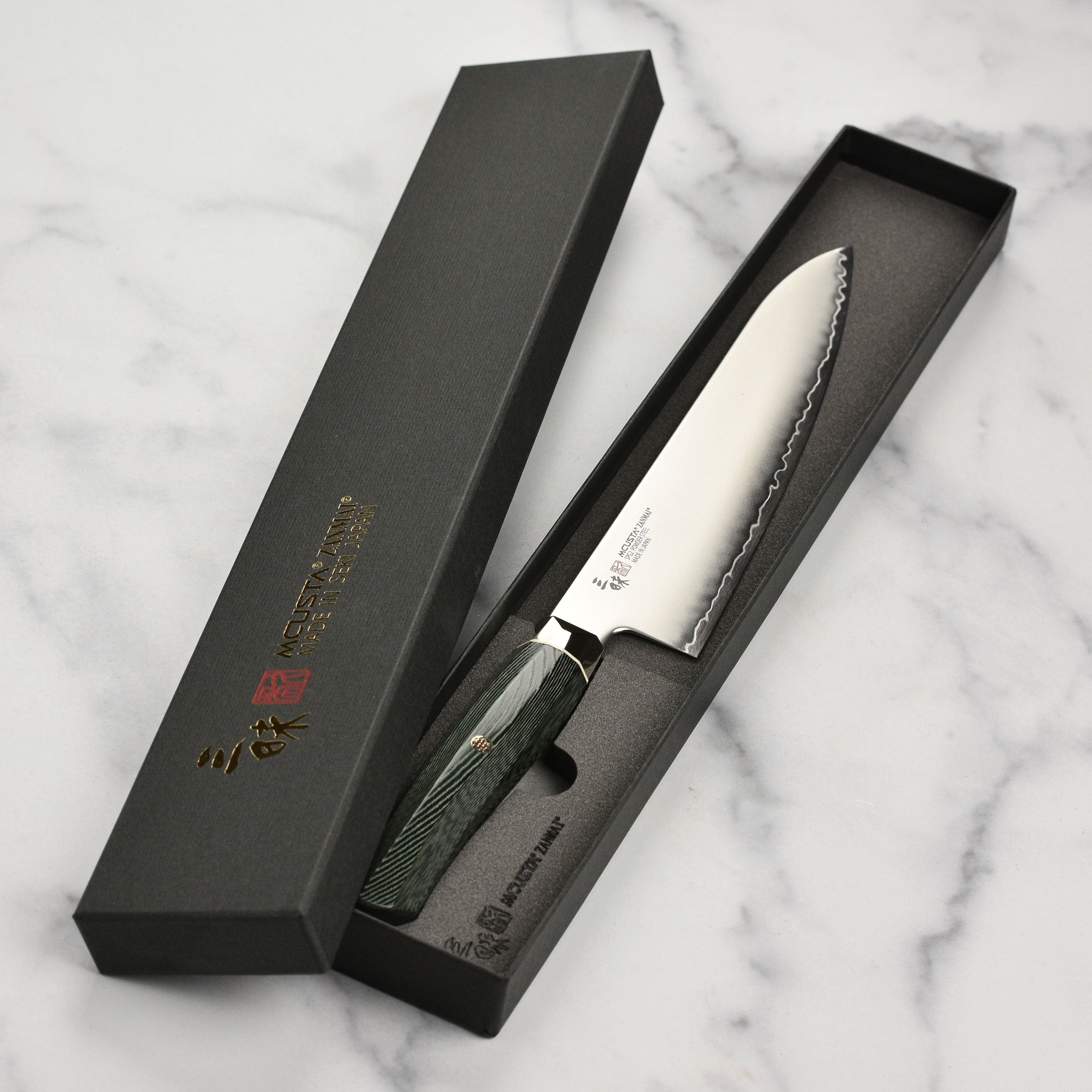 The Zanmai Revolution knife in action, expertly slicing vegetables on a wooden surface.