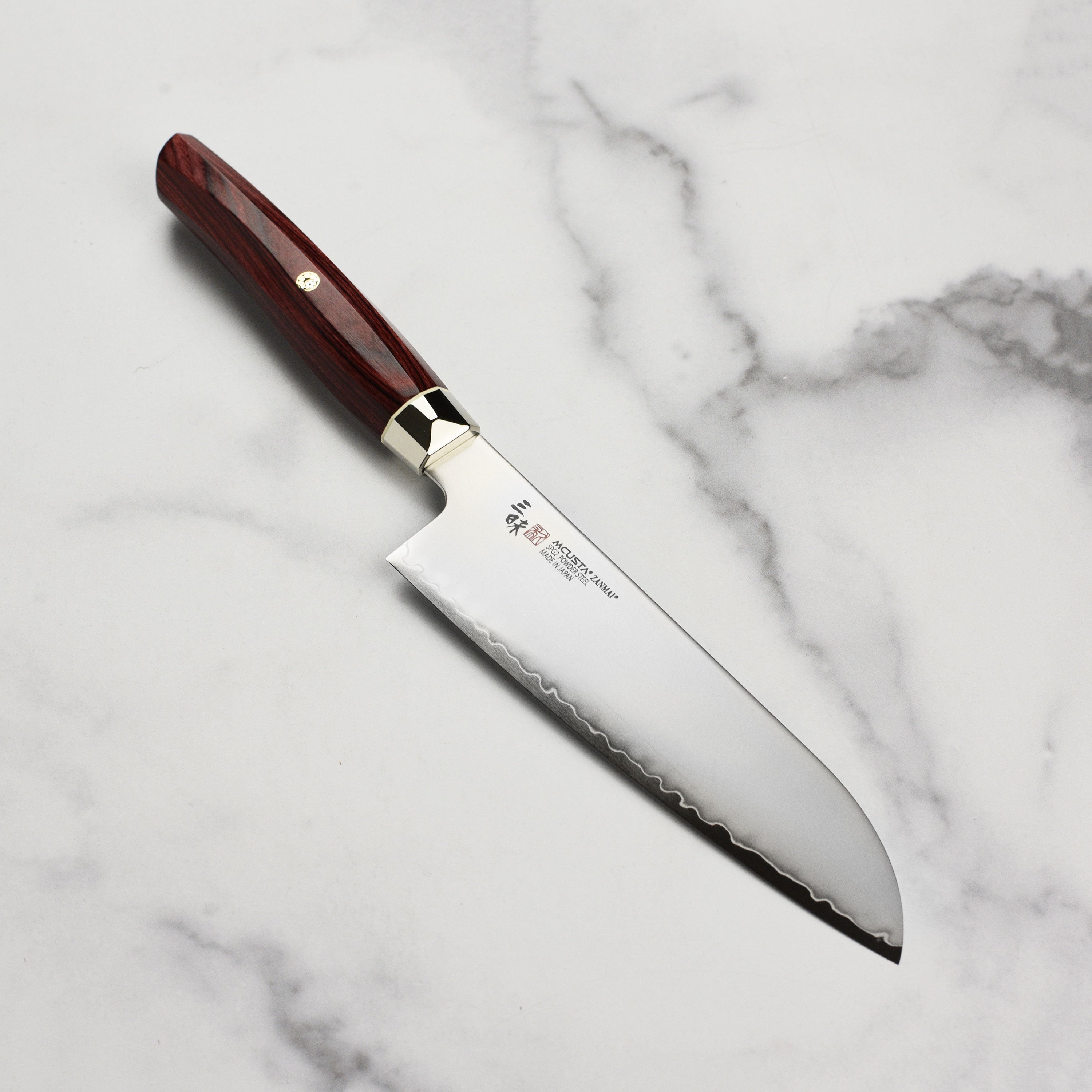 SG2 steel knife showcasing its sharp edge and Pakkawood handle from above.