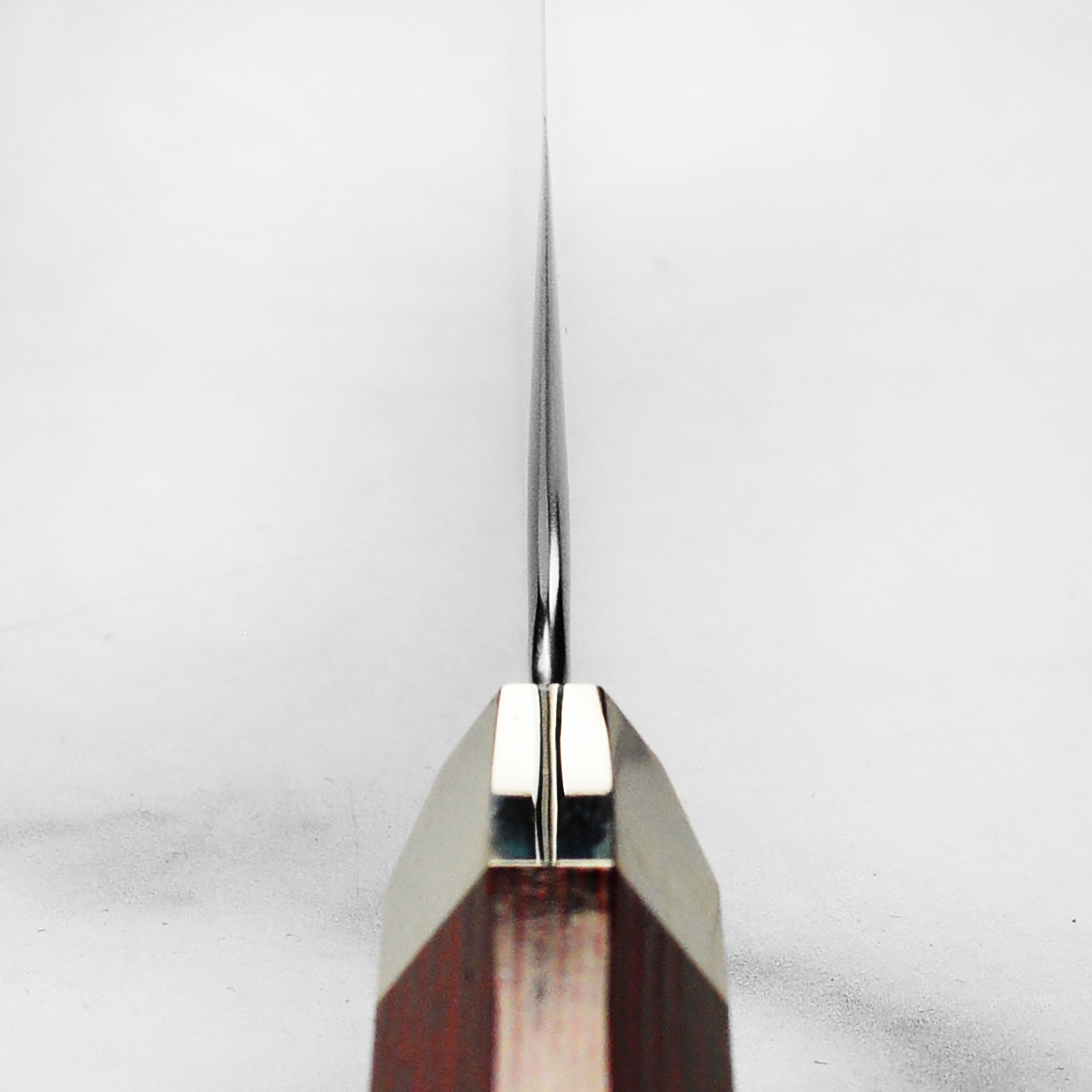 Front view of Zanmai Supreme Damascus Gyuto with hammered finish and Pakkawood handle