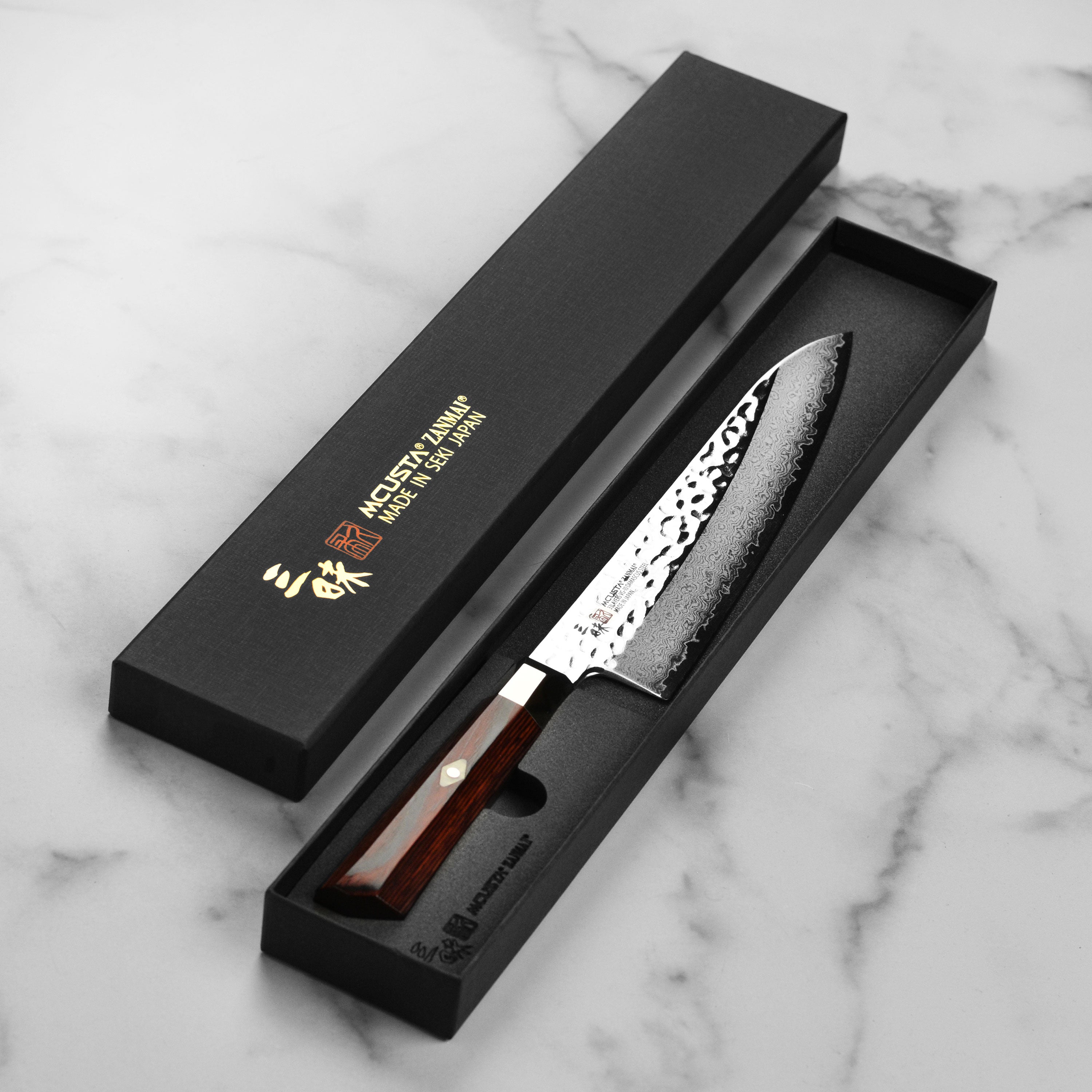 Japanese chef slicing vegetables with the handcrafted Damascus kitchen knife