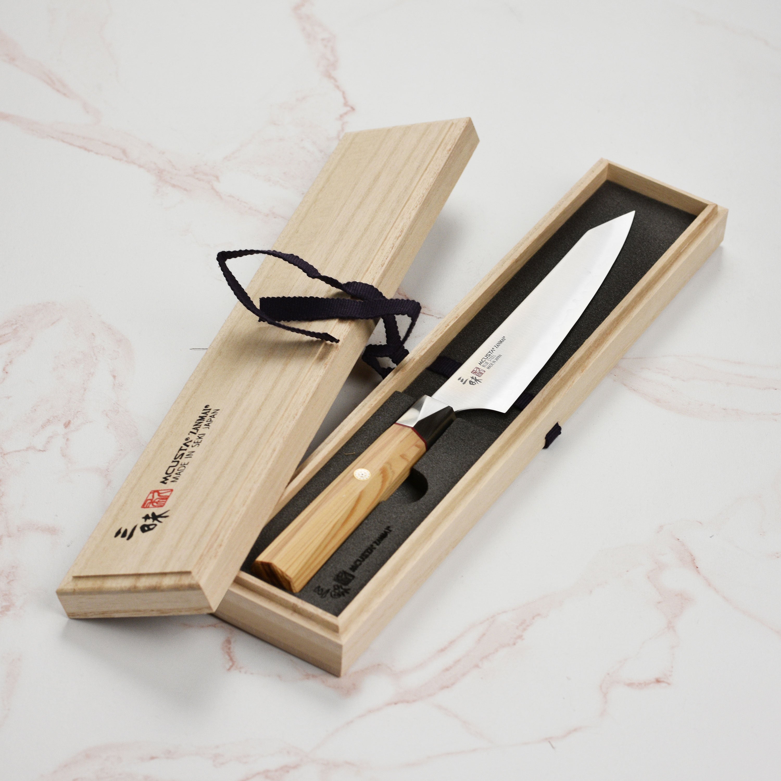 Profile shot of the Zanmai Aogami Super knife demonstrating its sleek design and craftsmanship.