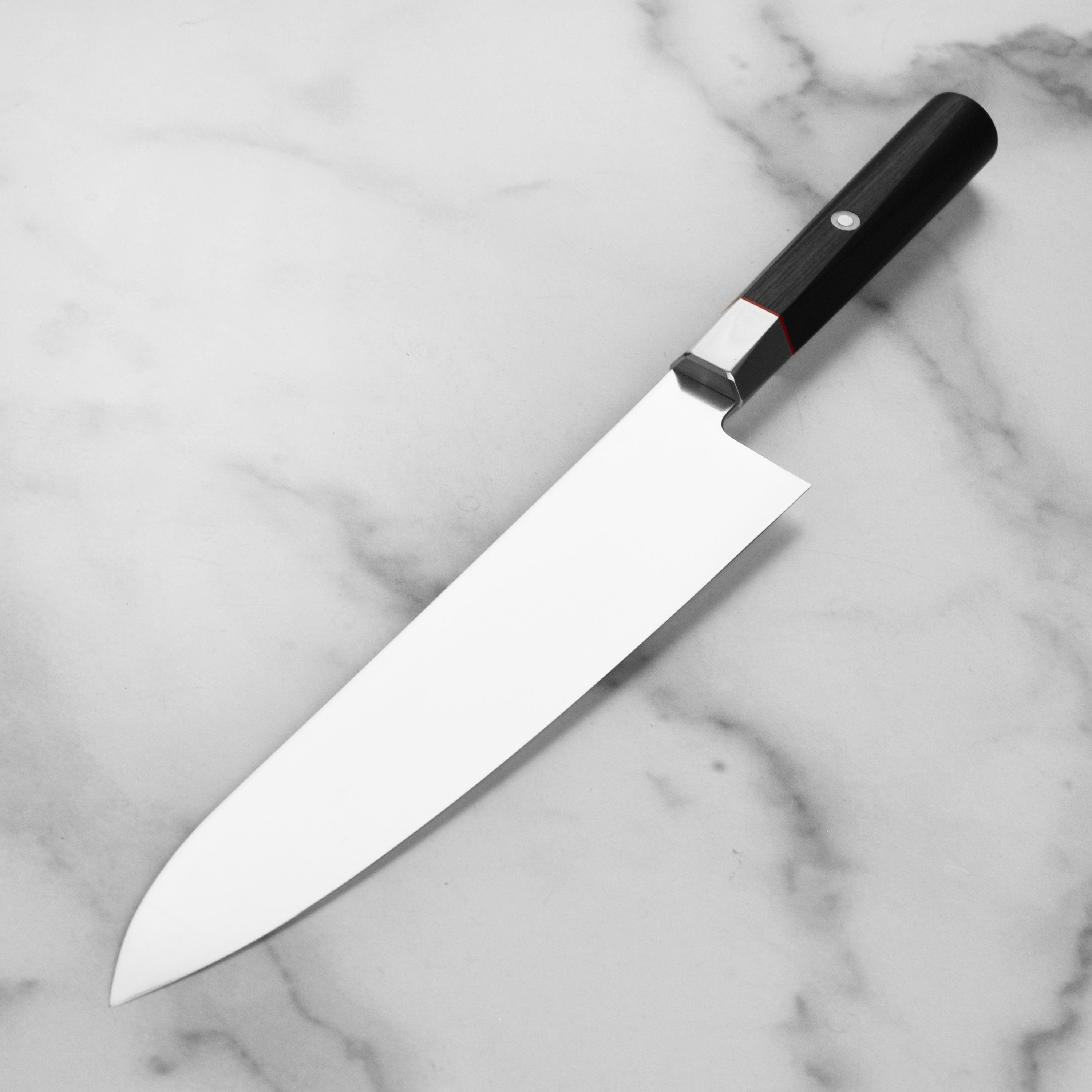 Close-up of the knifes blade showing the VG10 steel and 61 Rockwell hardness, perfect for professional chefs.