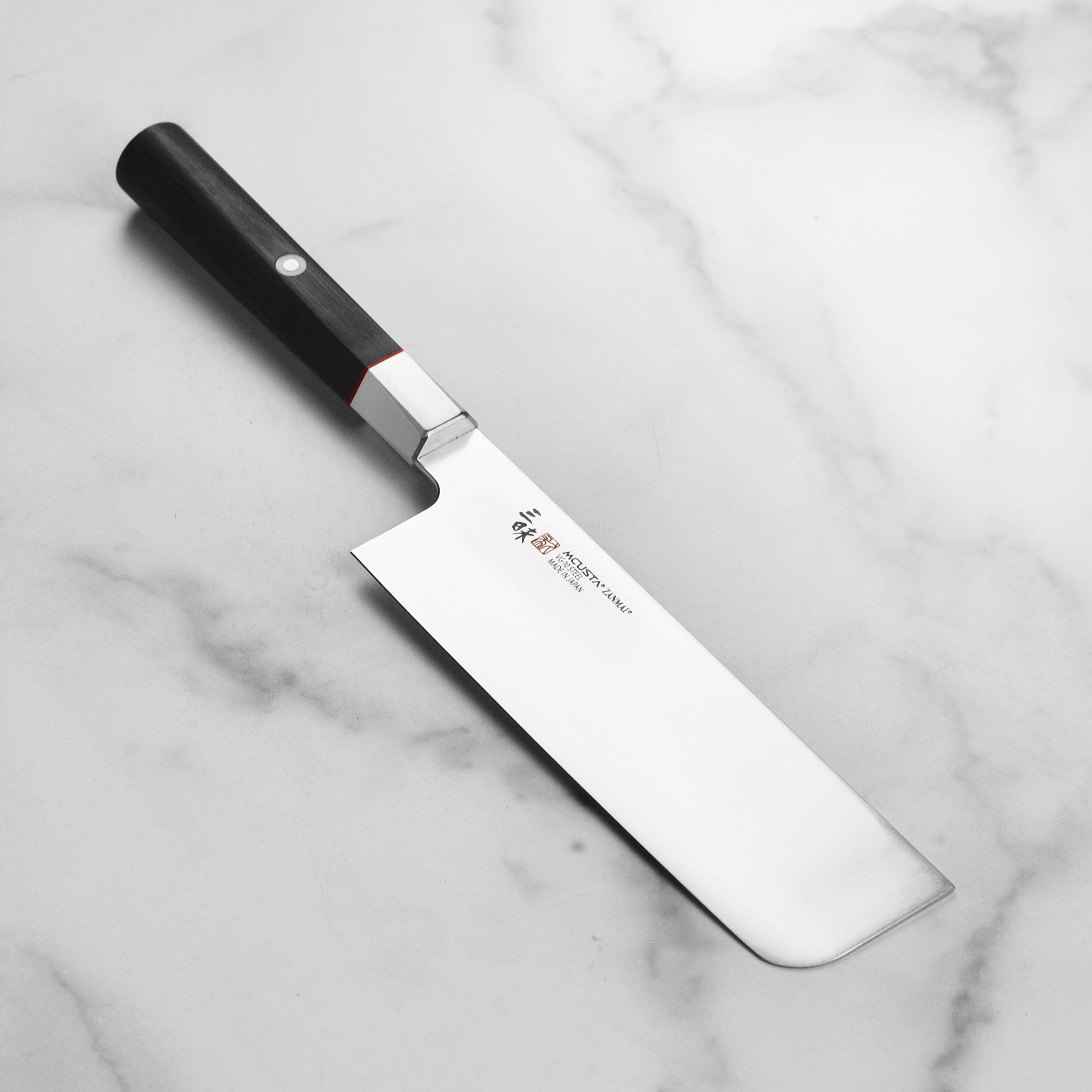 Zanmai Premium VG10 Nakiri Knife showcasing its sharp blade and elegant handle from a side angle.