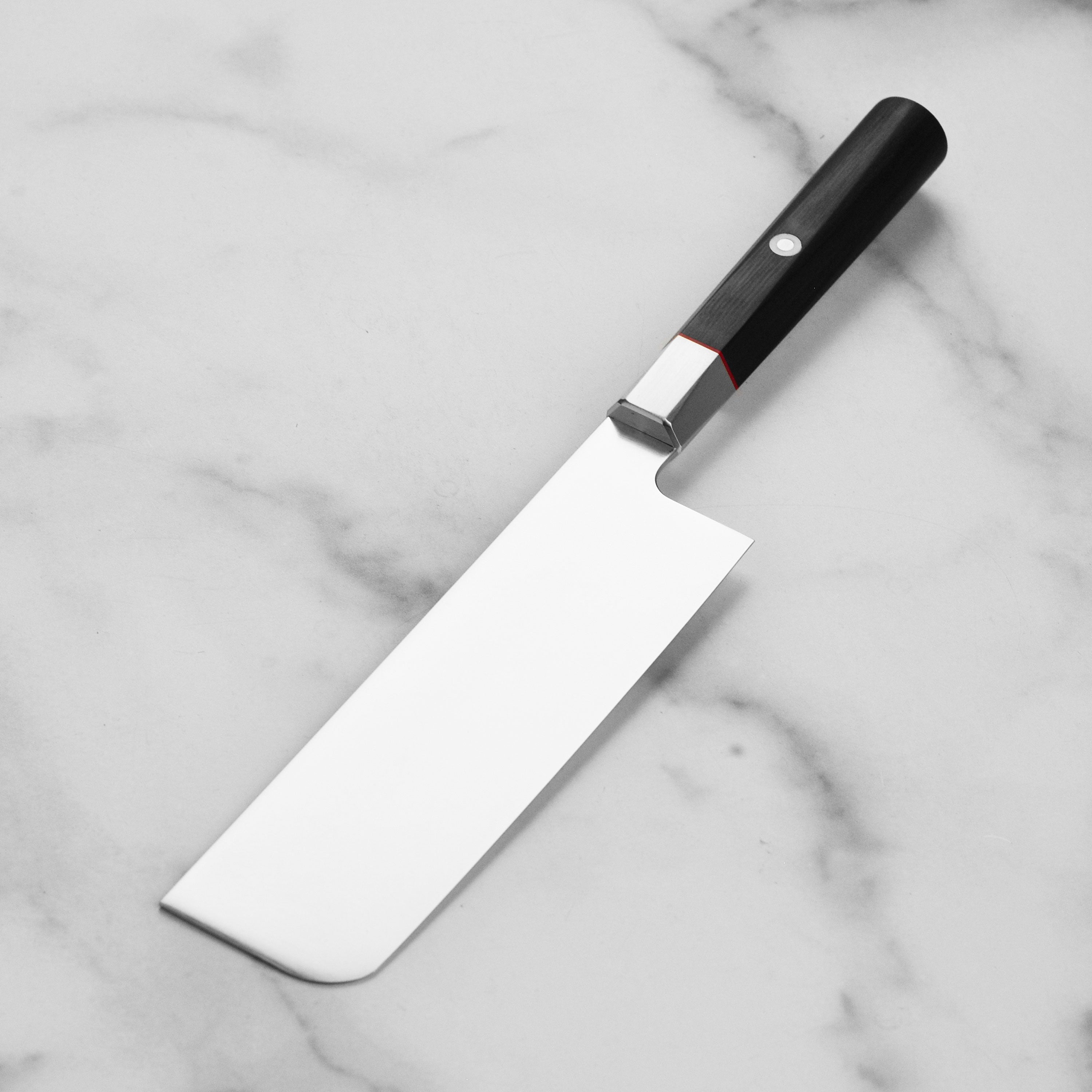Close-up of the Black Pakkawood handle of the Zanmai Nakiri knife with red spacer and mosaic pin.