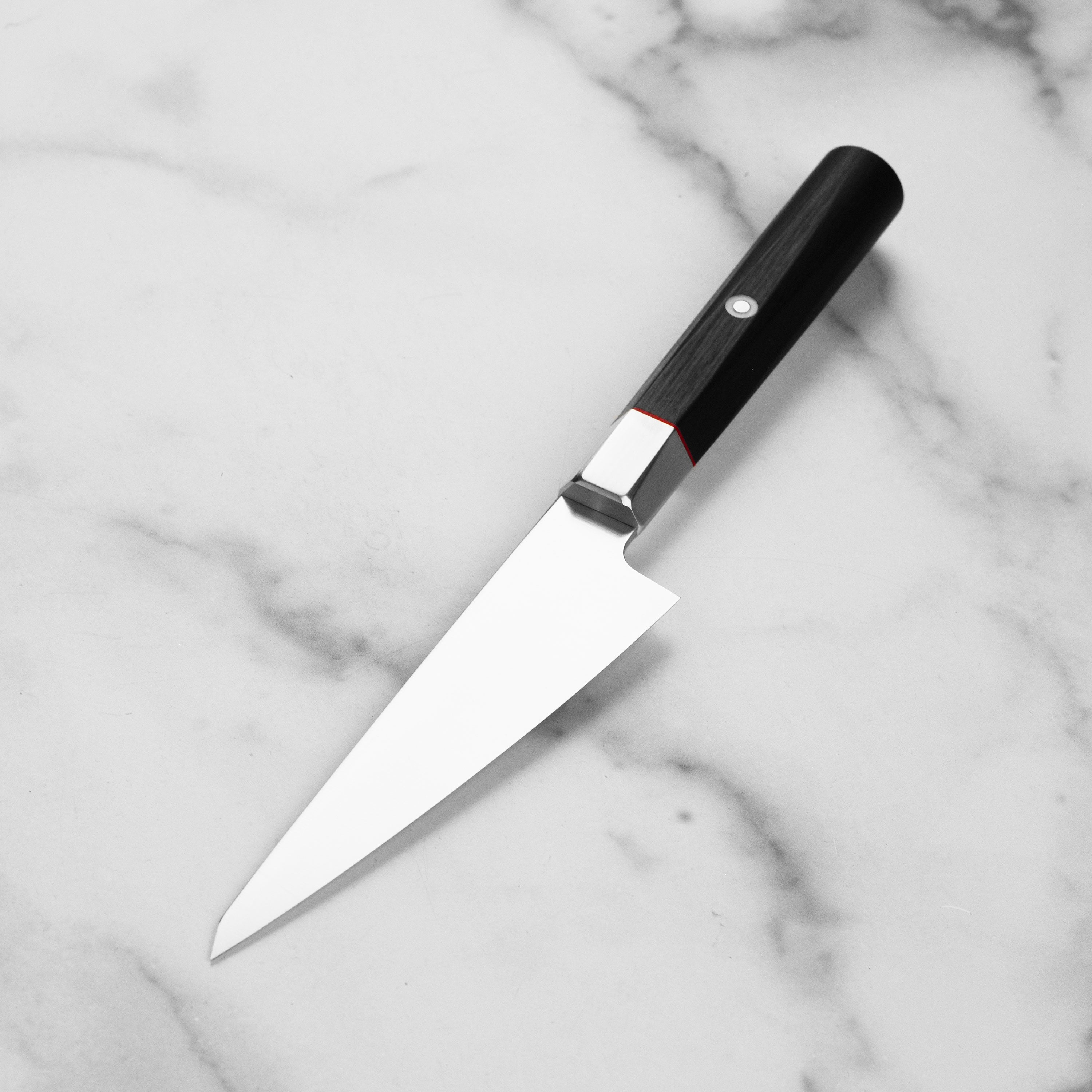 Seki City Premium VG10 Honesuki Knife in use, expertly slicing through poultry.