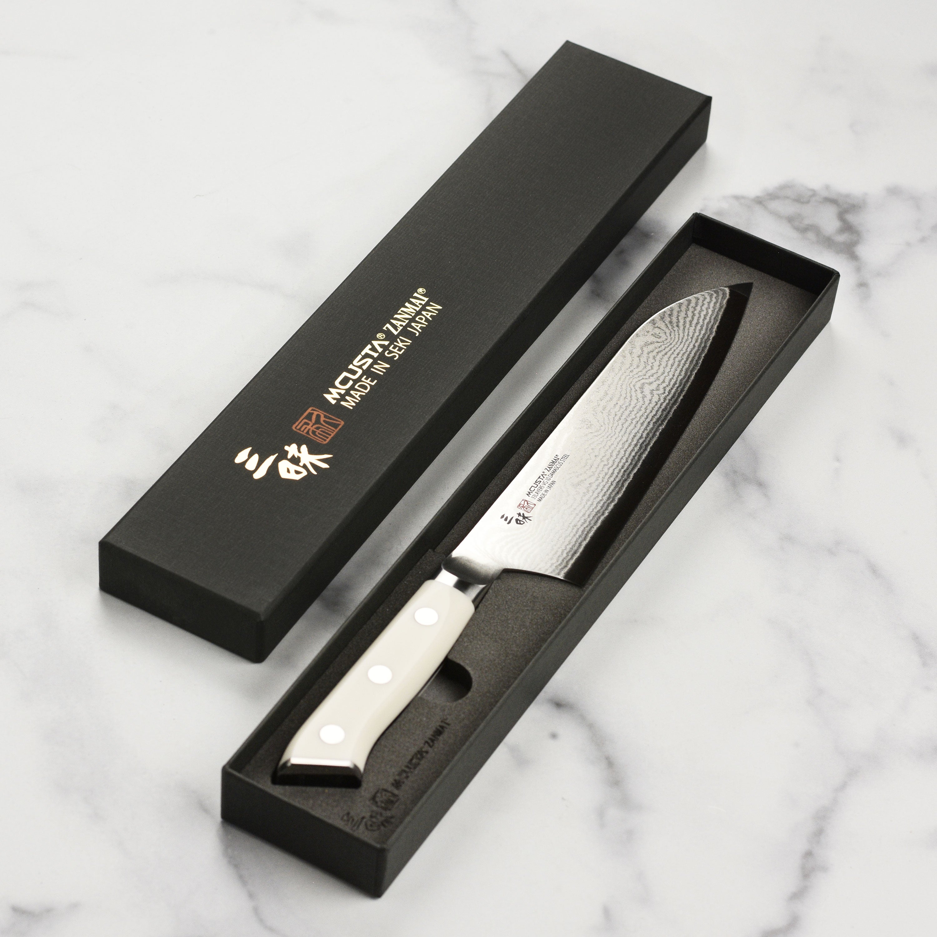 Zanmai Classic Santoku Knife displayed with fresh ingredients, showcasing its cutting precision