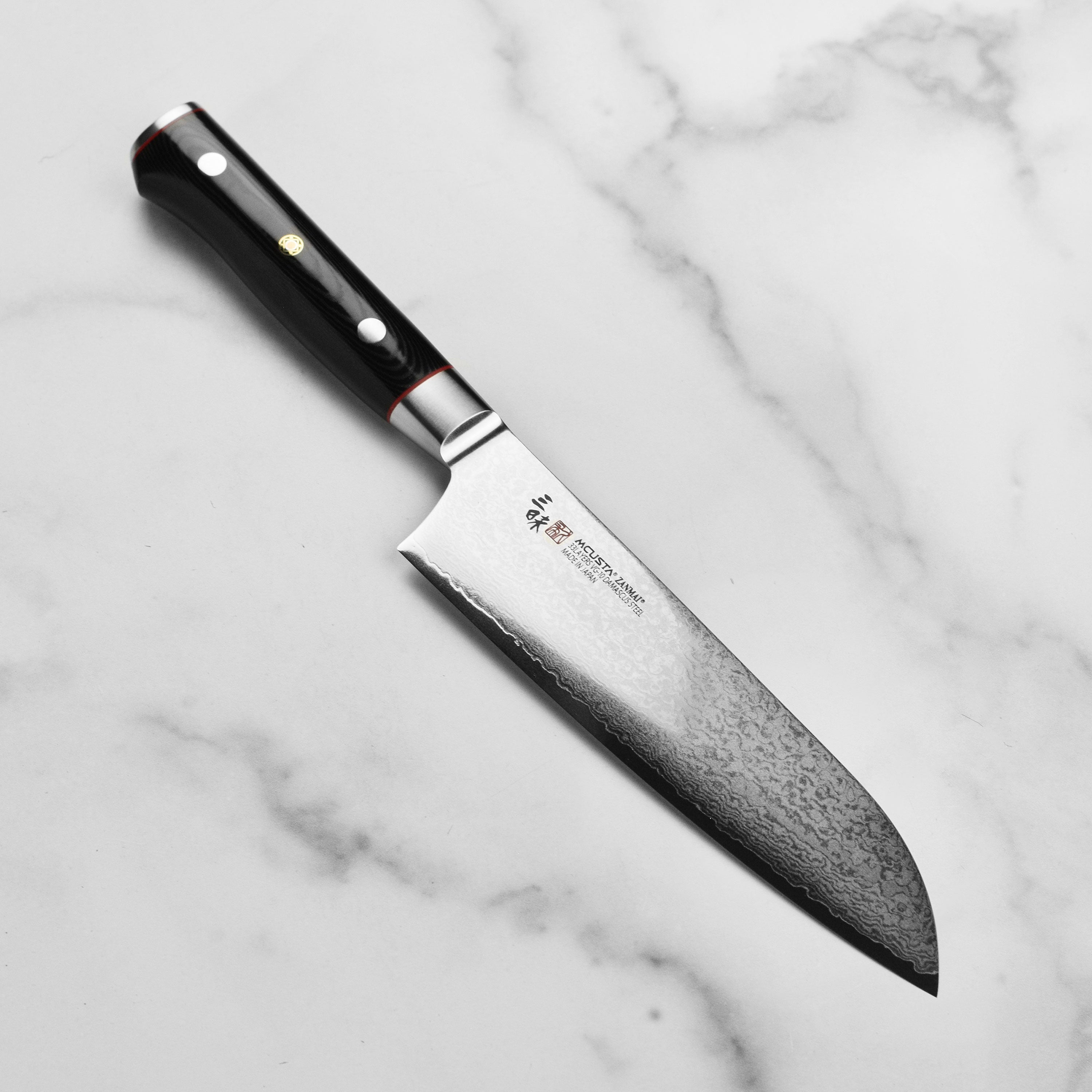 Zanmai Premium Damascus Santoku Knife showcasing its 33-layer blade and elegant Micarta handle.