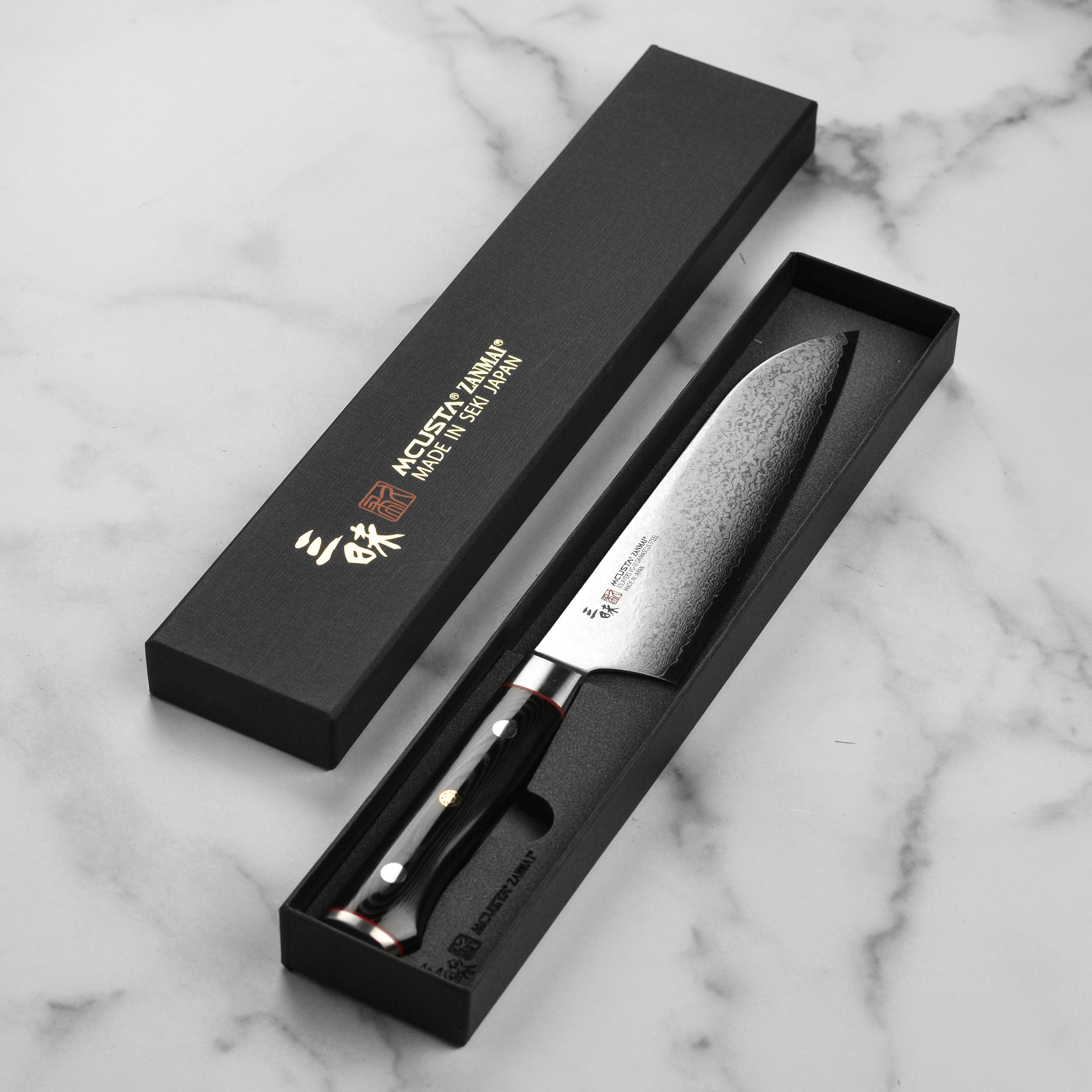 The Zanmai 7-inch Santoku knife in action, effortlessly slicing through vegetables on a wooden cutting board.