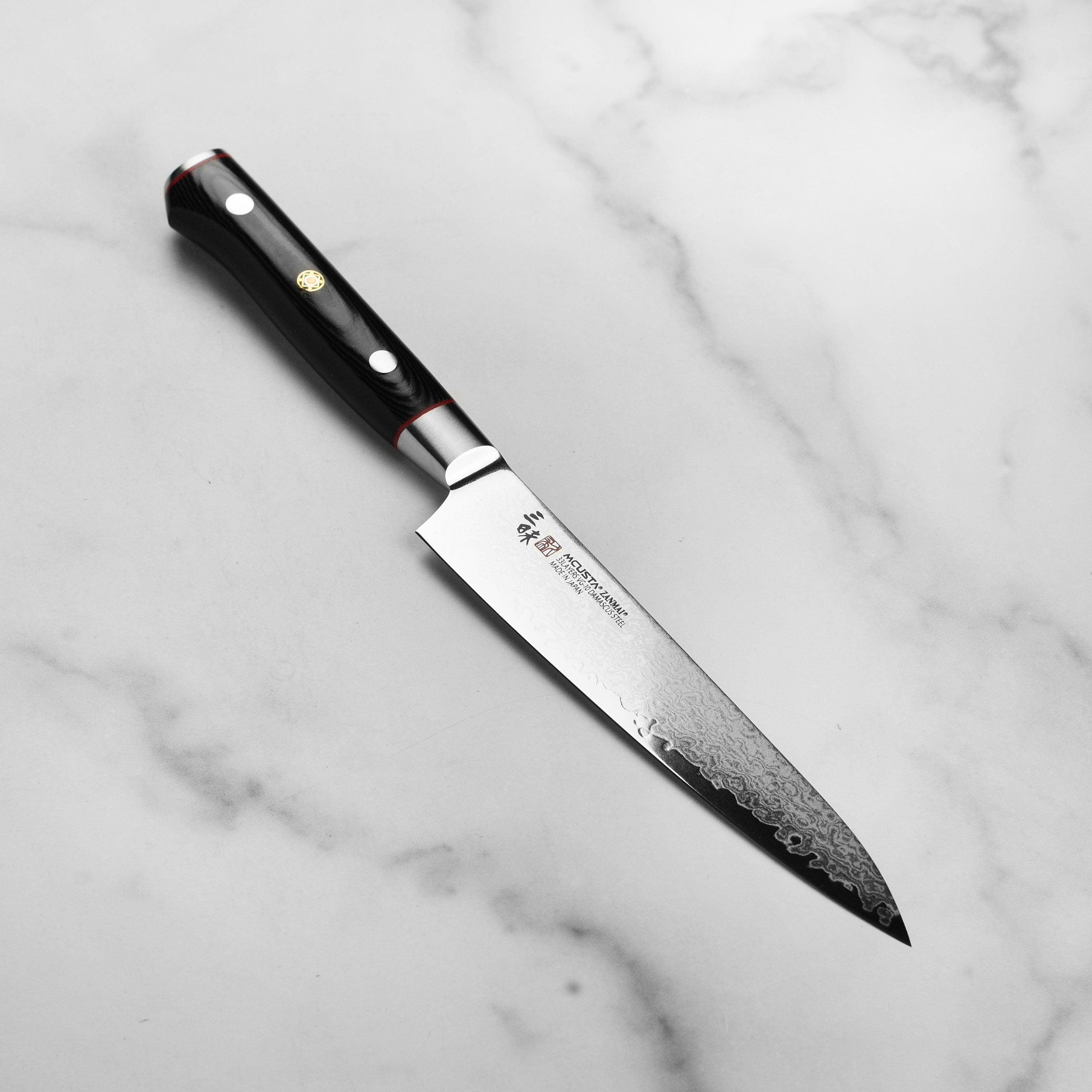 Zanmai Pro Zebra Damascus knife showcasing its elegant handle and blade design