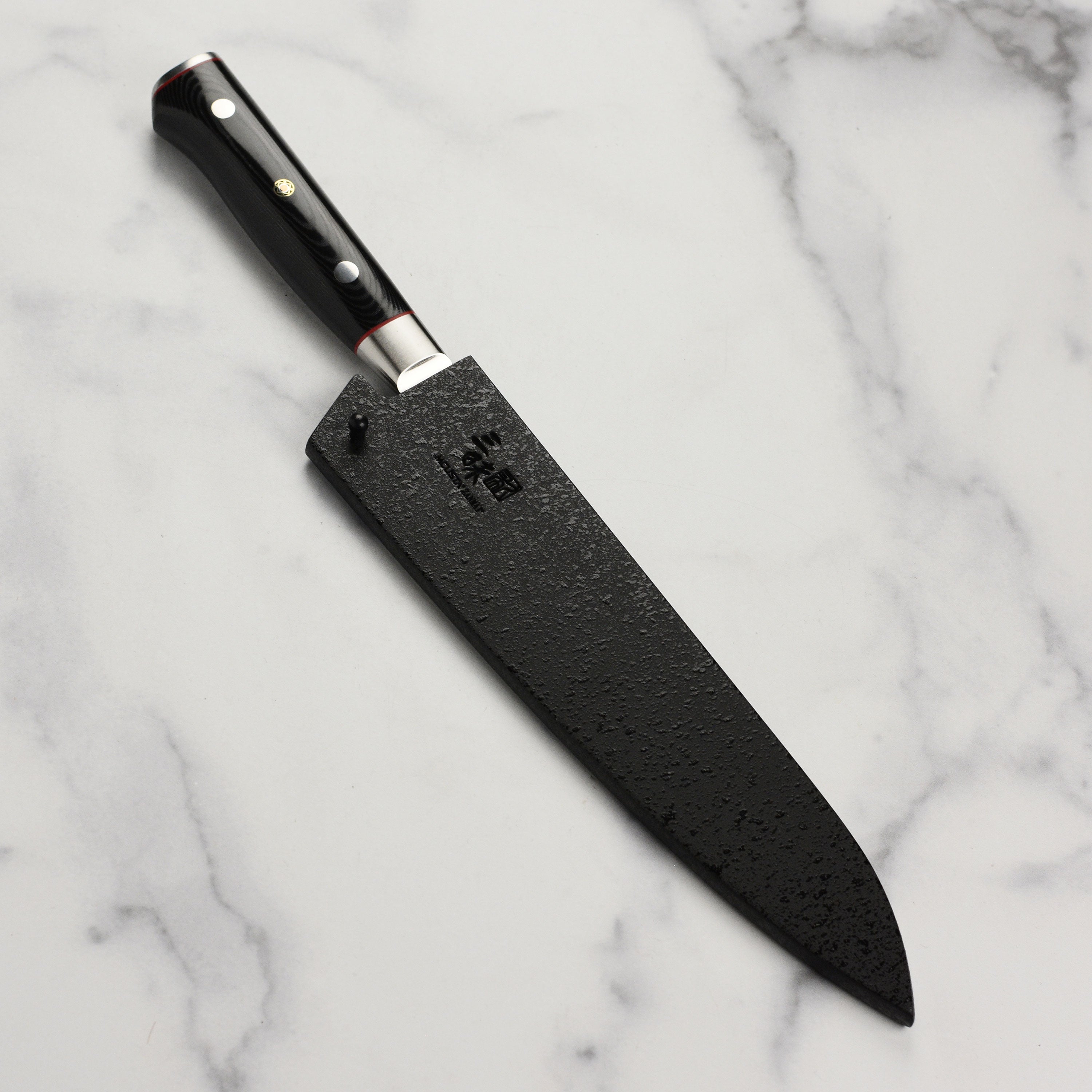 Black lacquer saya displaying the secure locking mechanism for safe knife storage.