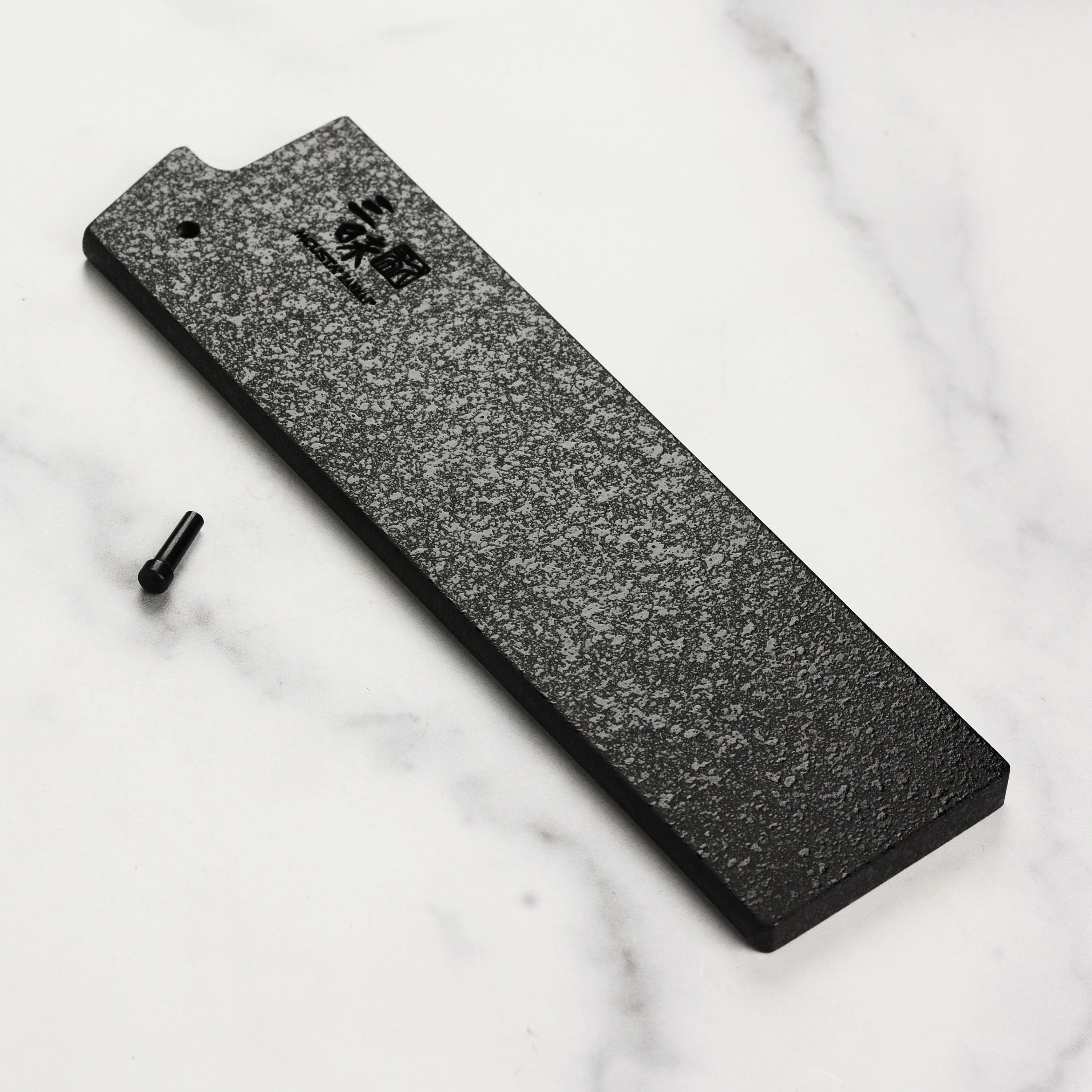 Close-up of Zanmai black lacquer saya with engraved logo for Nakiri knife