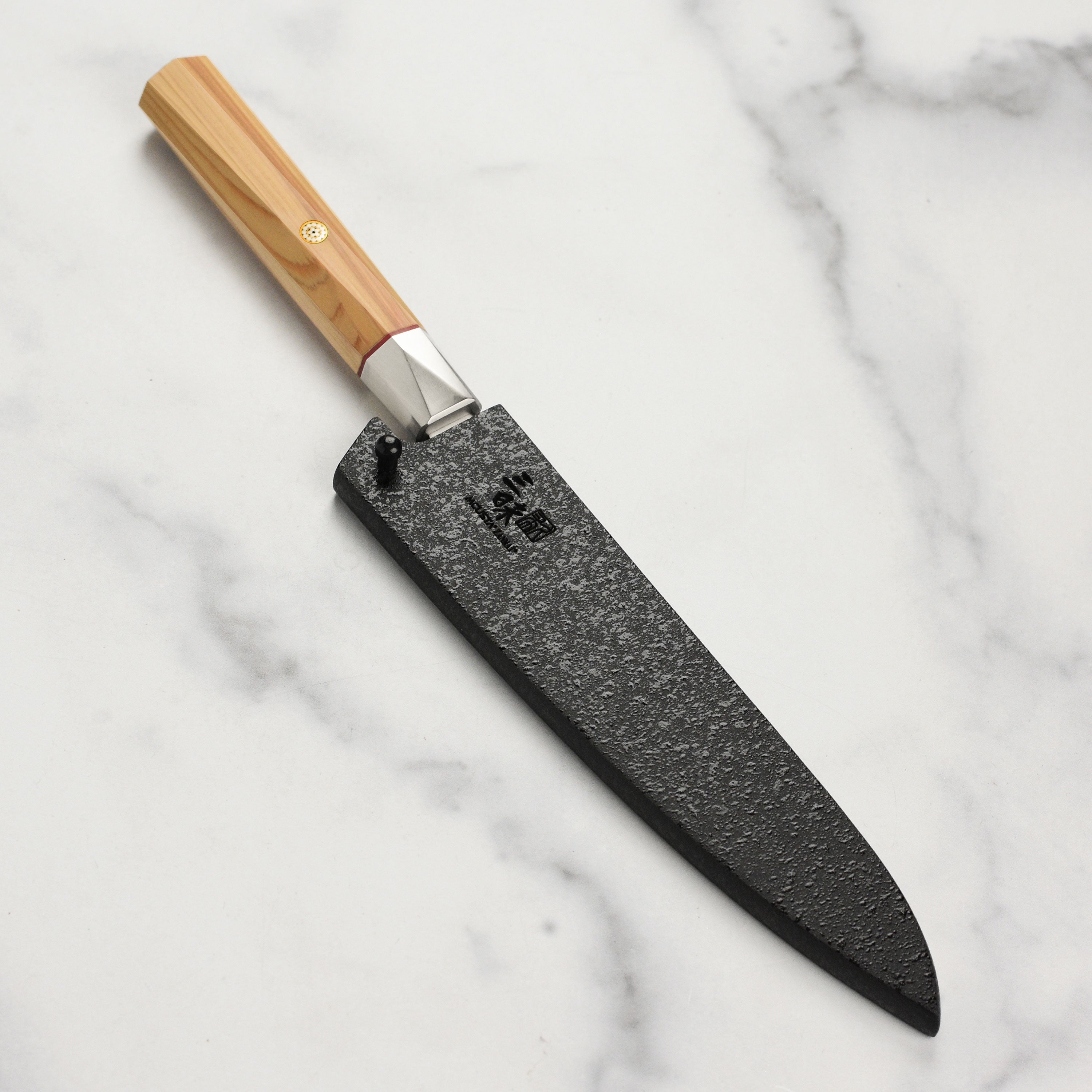 Close-up of the black mosaic pattern on the secure locking knife sheath for chefs.