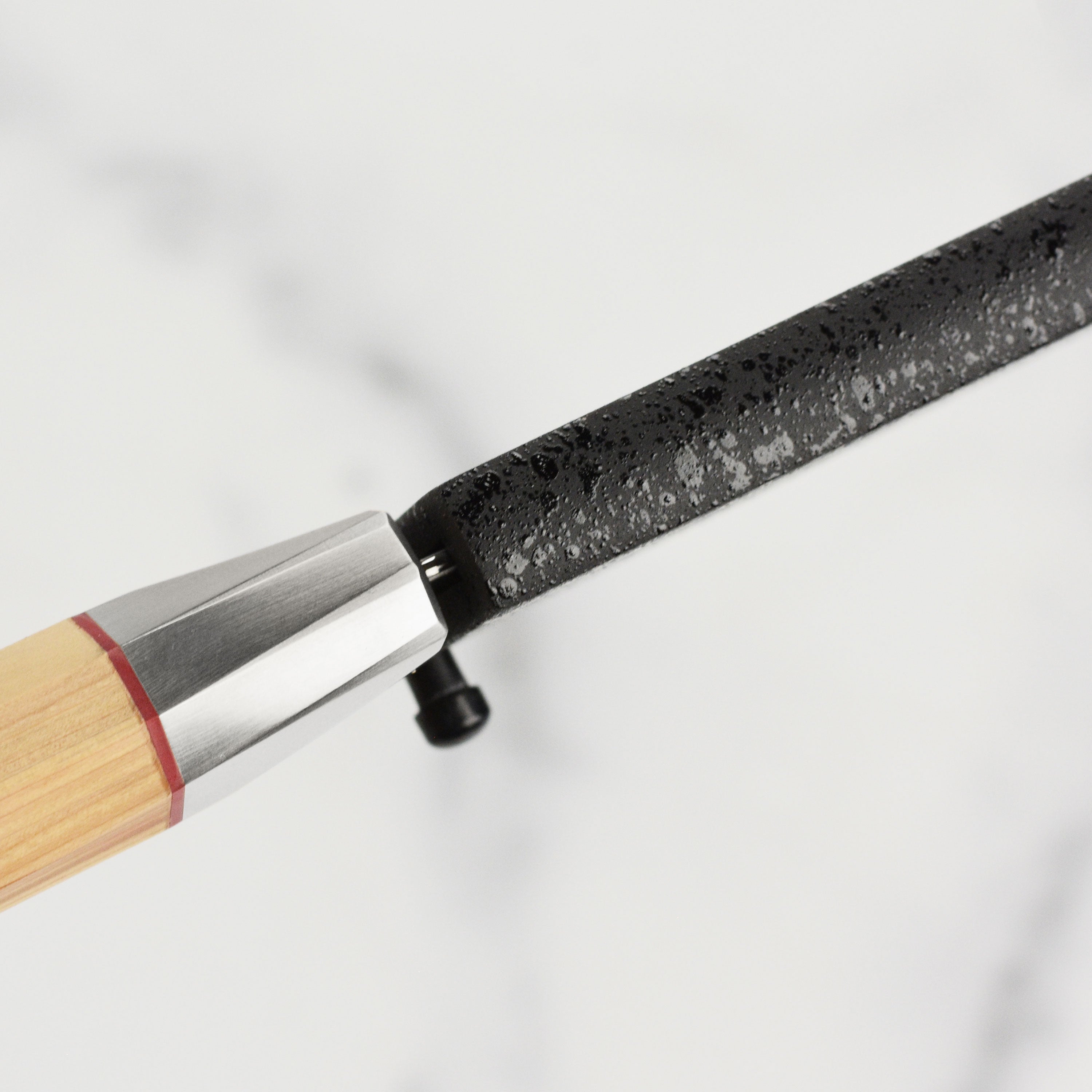 Elegant black lacquer knife sheath showcasing the engraved logo and locking mechanism.