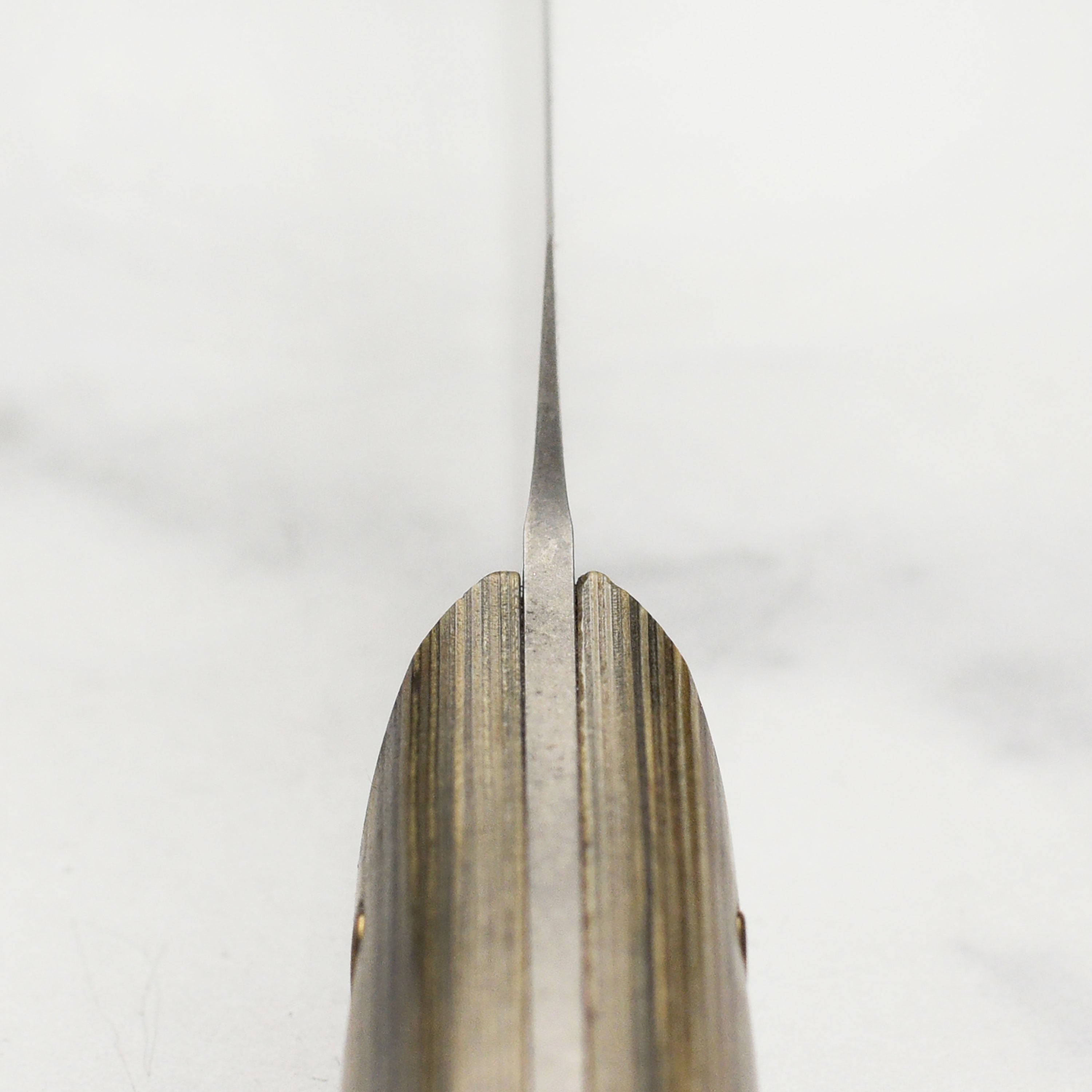 Close-up view of the Messermeister Artisan Carbon Utility Knife blade highlighting its carbon steel finish.
