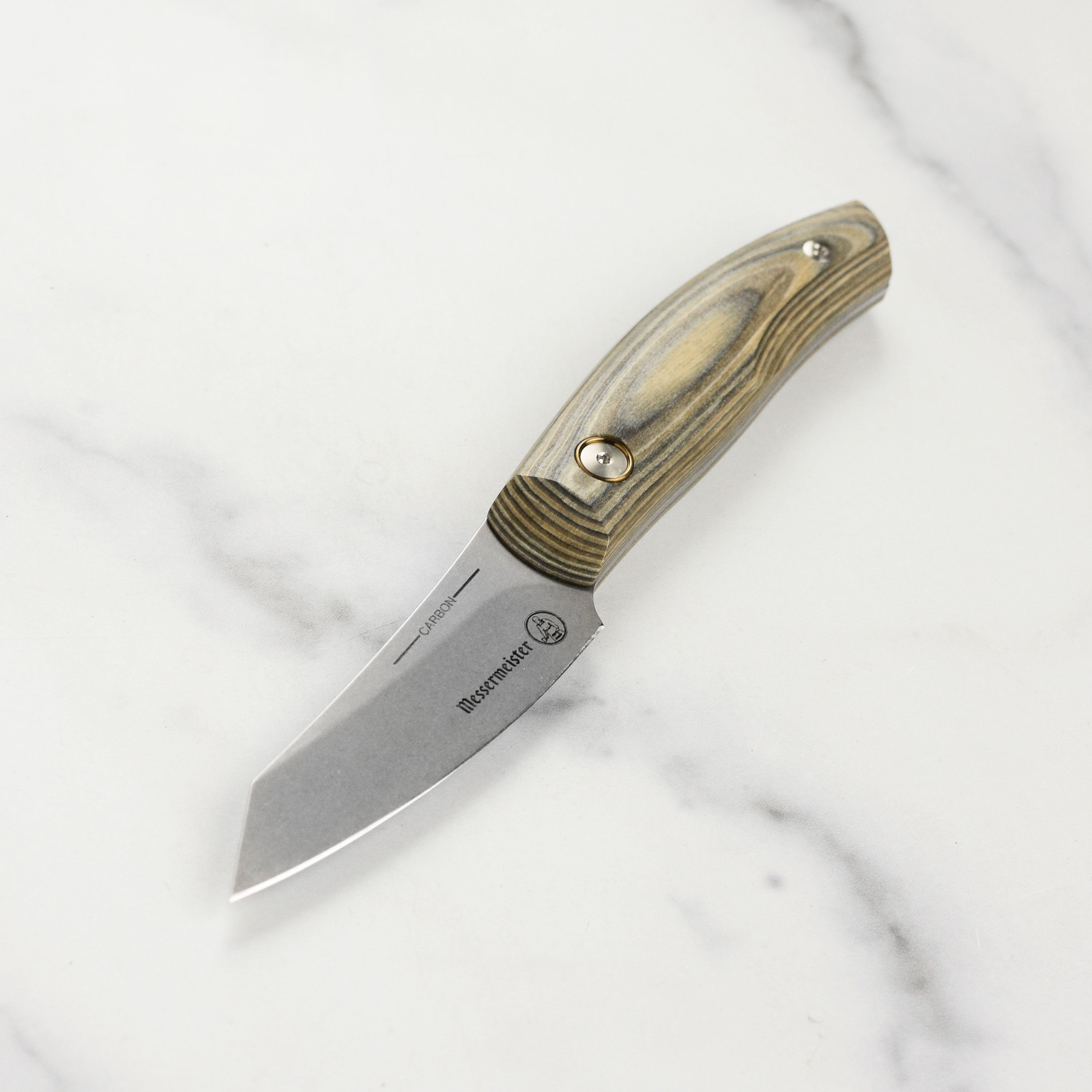 Close-up of handcrafted high carbon steel paring knife showing blade detail