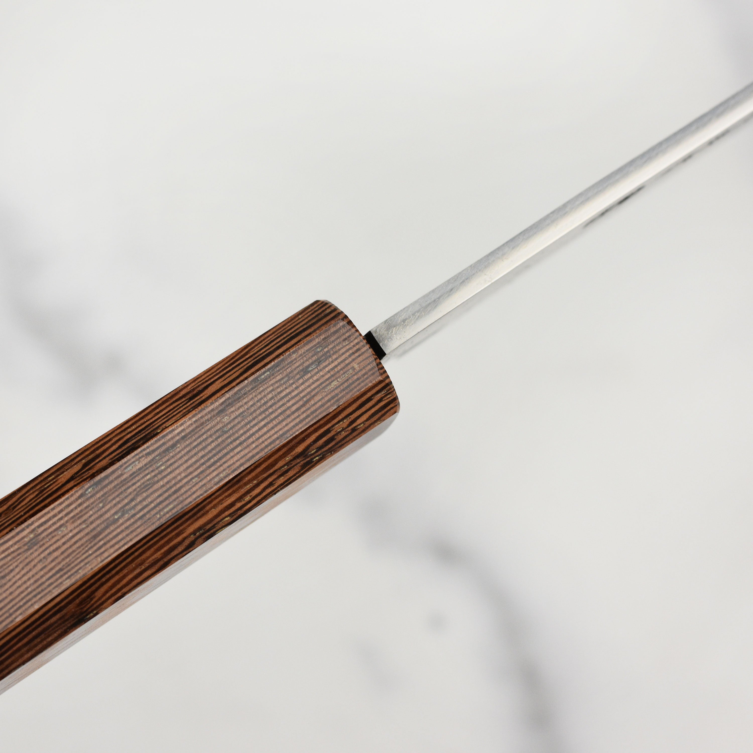 Close-up of the Premium Hand-Forged Shirogami 8.25" Gyuto Knife, highlighting its sharp blade and craftsmanship.