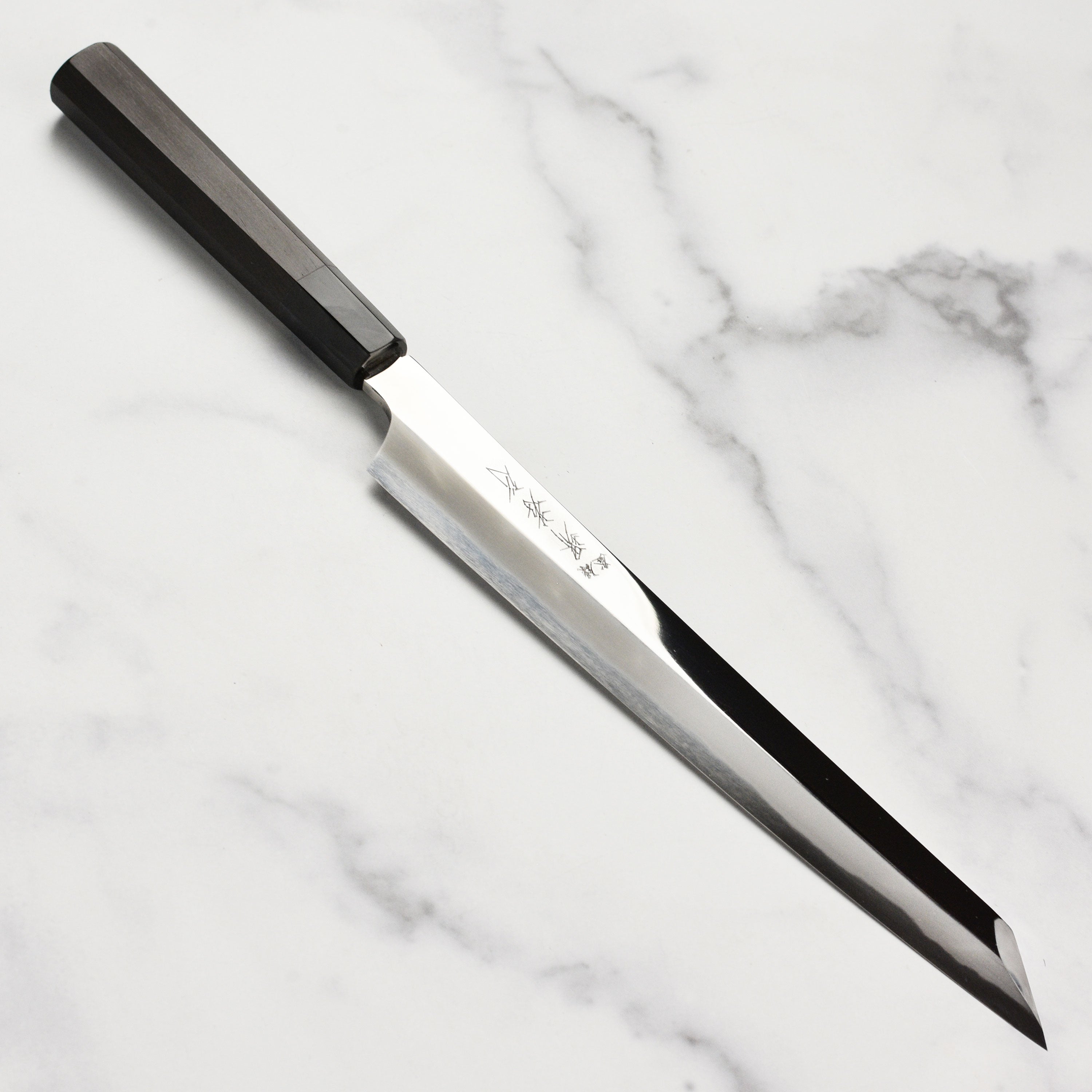 Handmade Japanese kitchen knife with ebony handle, perfect for sushi chefs