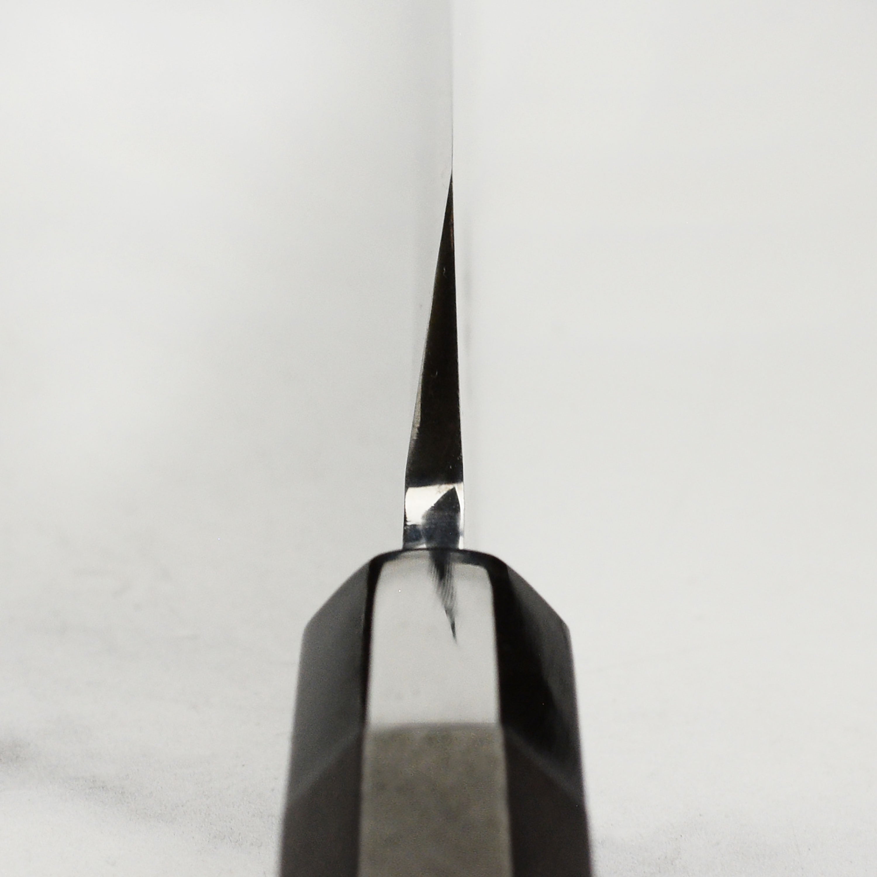 Handmade Japanese kitchen knife with ebony handle, perfect for sushi chefs