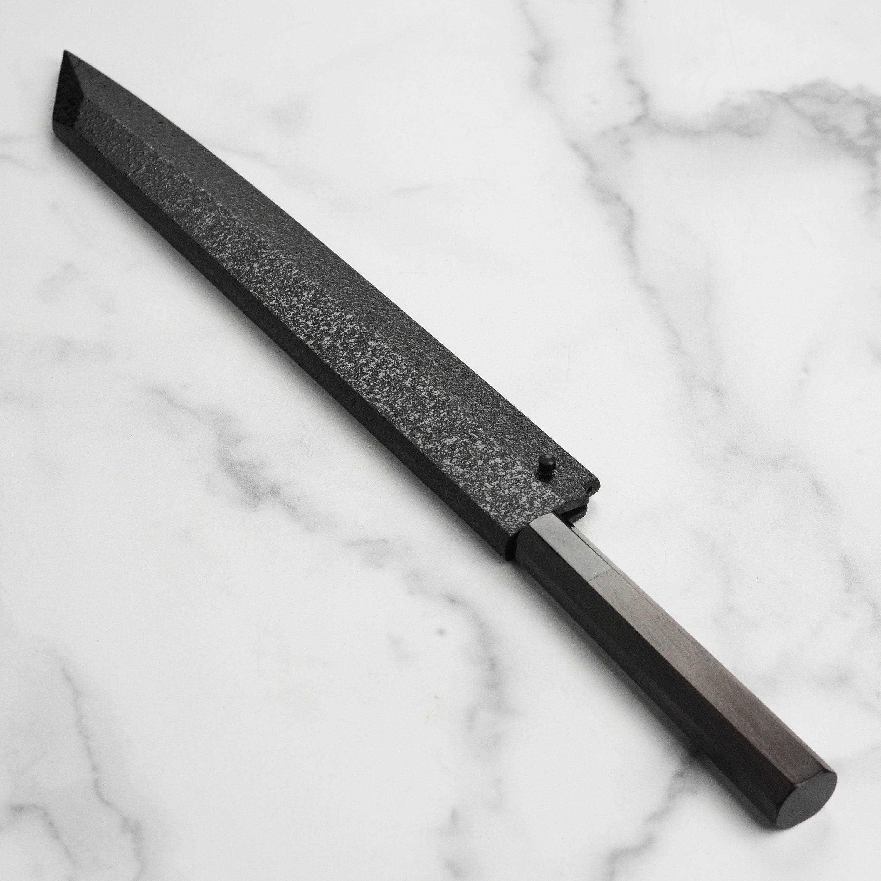 Detailed view of the high carbon steel blade, highlighting mirror finish and sharp edge