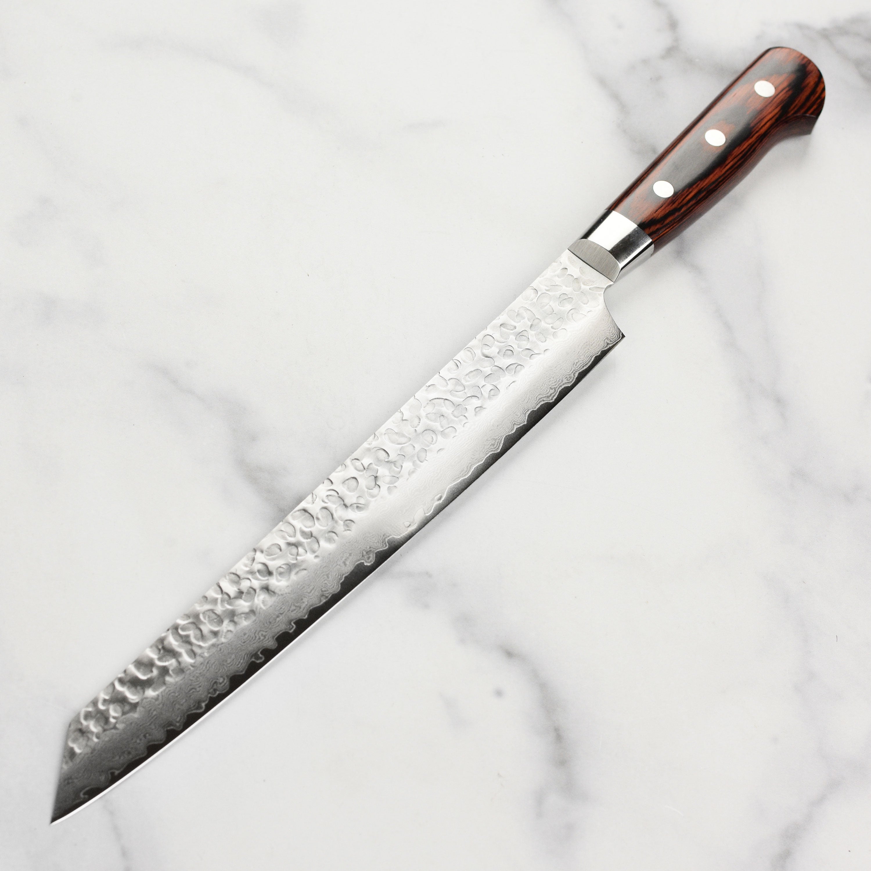 The mahogany Pakkawood handle of the Takayuki Yanagiba Knife, emphasizing its craftsmanship and comfort.