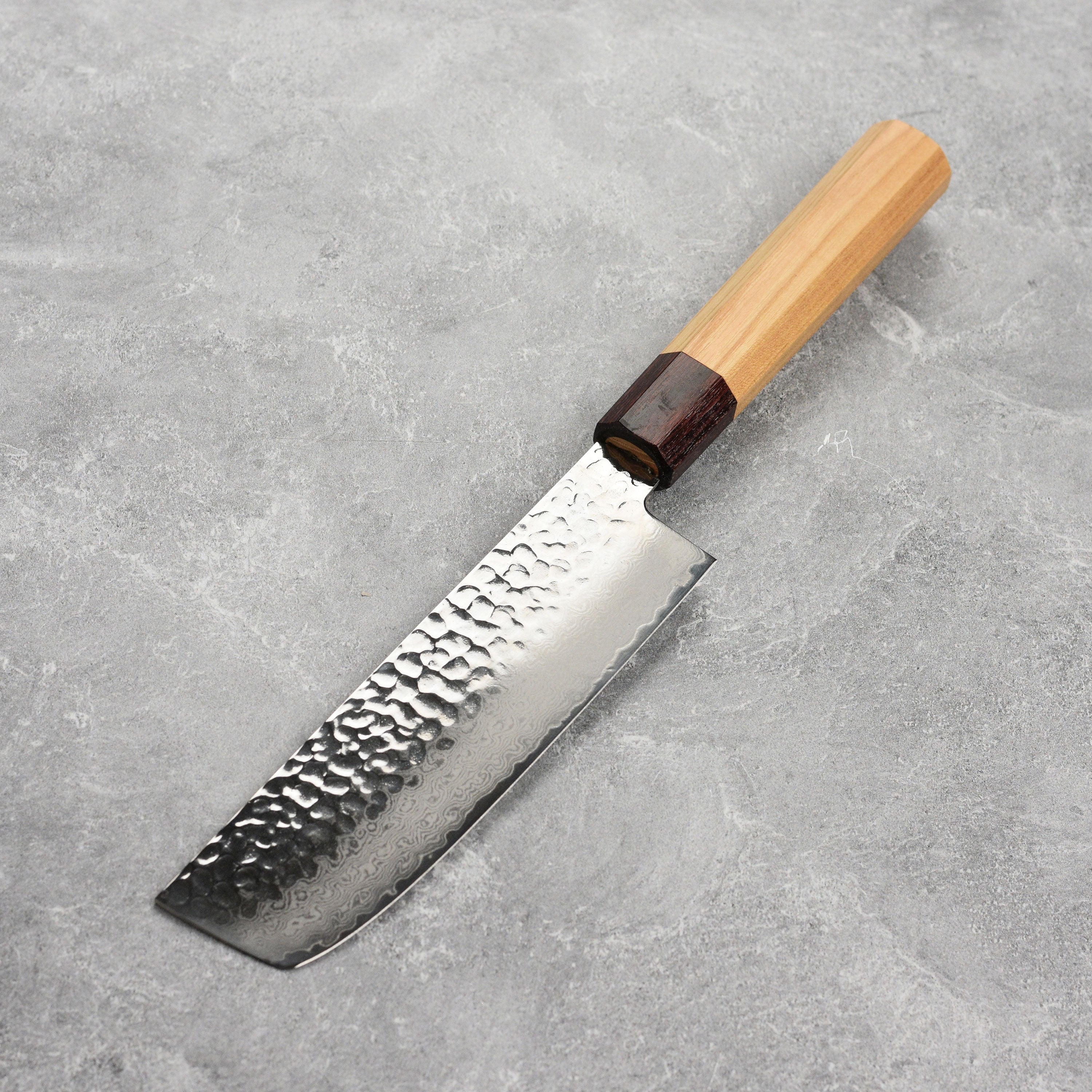 Takayuki Nakiri knife in use for slicing fresh vegetables on a wooden cutting board