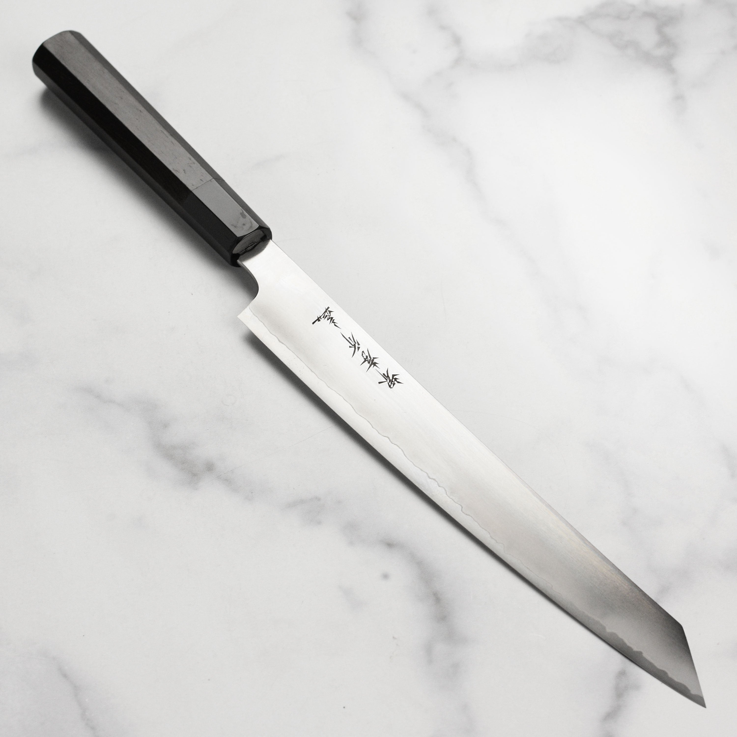 Takayuki Ginsan hand-forged Yanagiba slicing fish for sushi