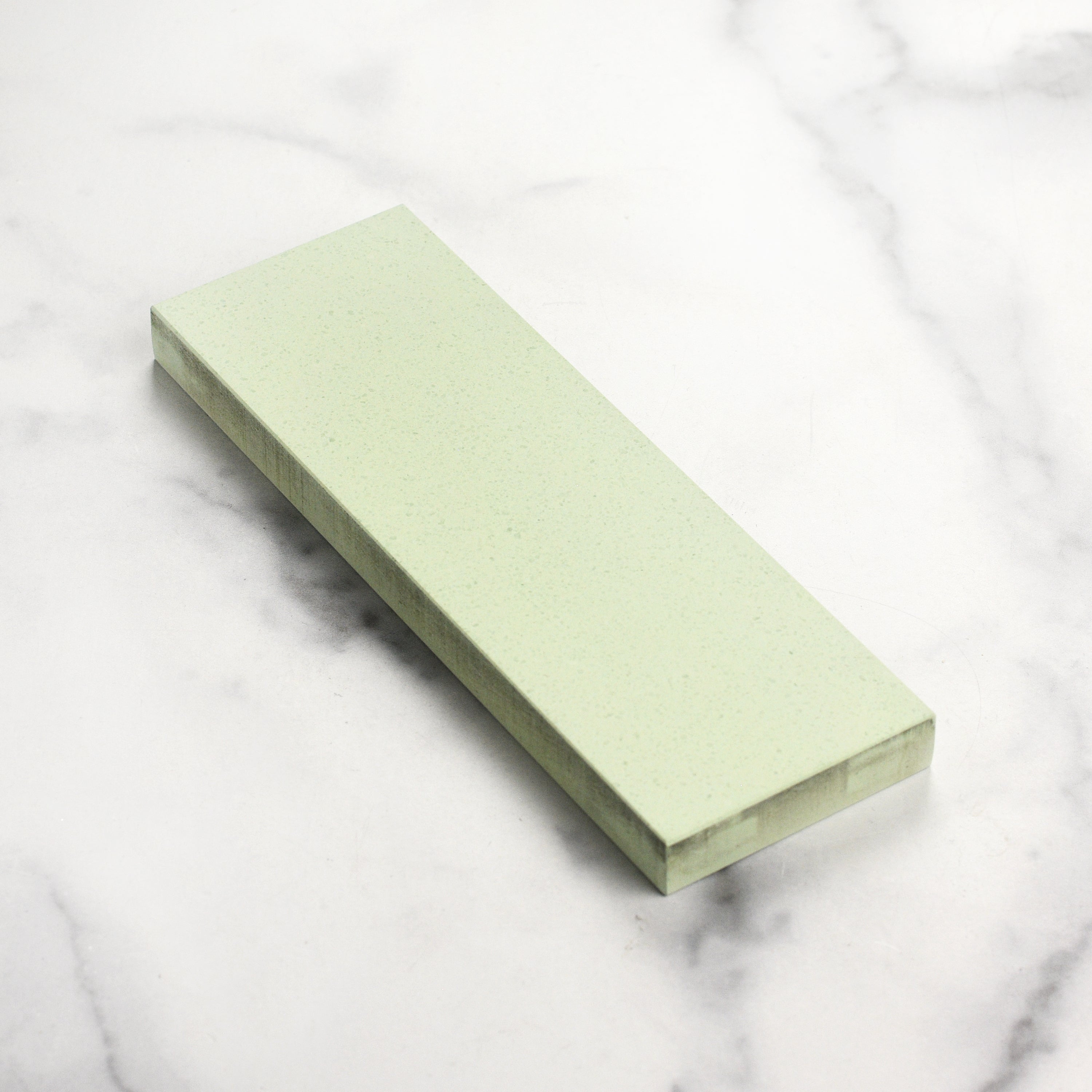 Knife sharpening in progress using the professional water stone in a kitchen setting