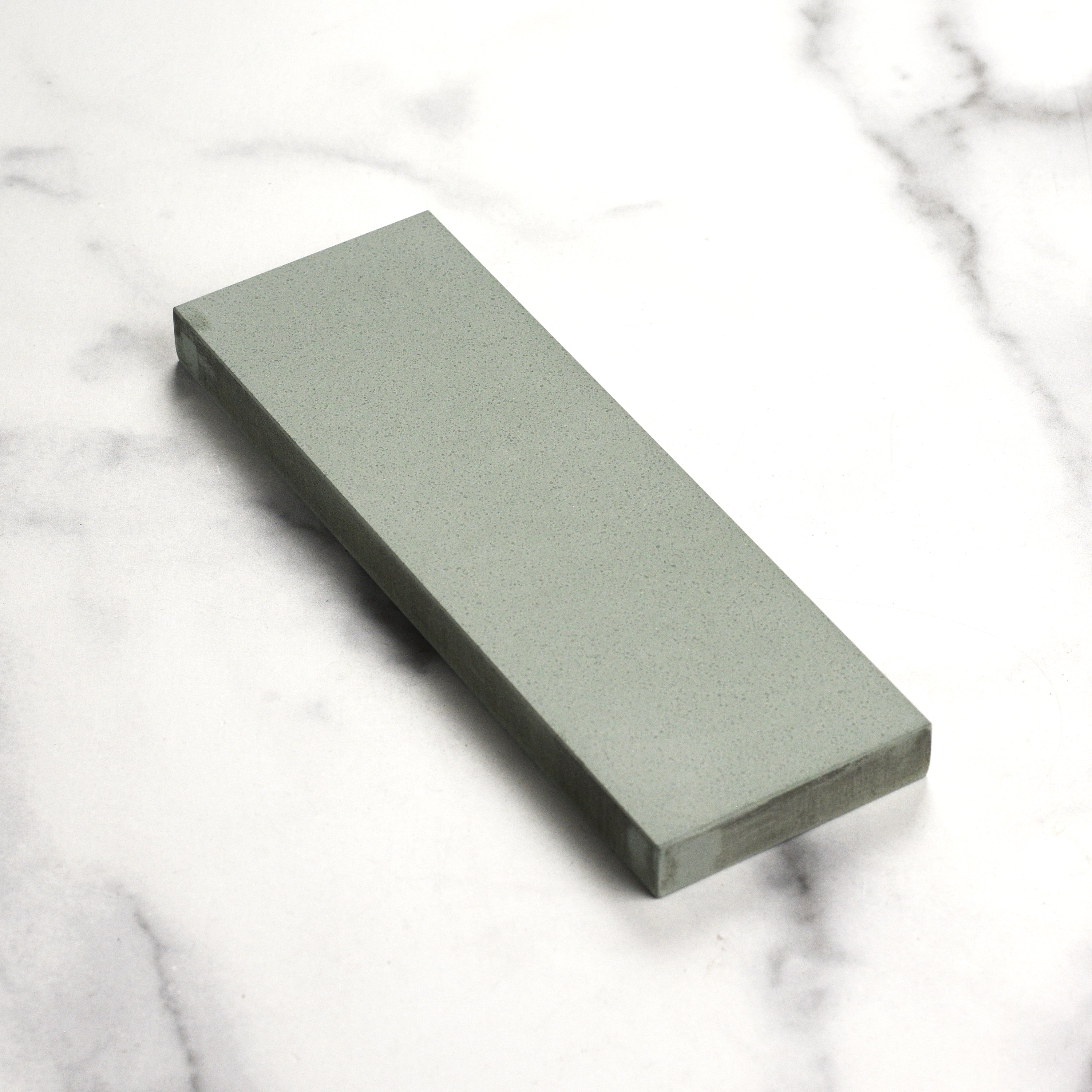 Close-up of the Shapton Kuromaku sharpening stone, demonstrating its dense texture and quality.