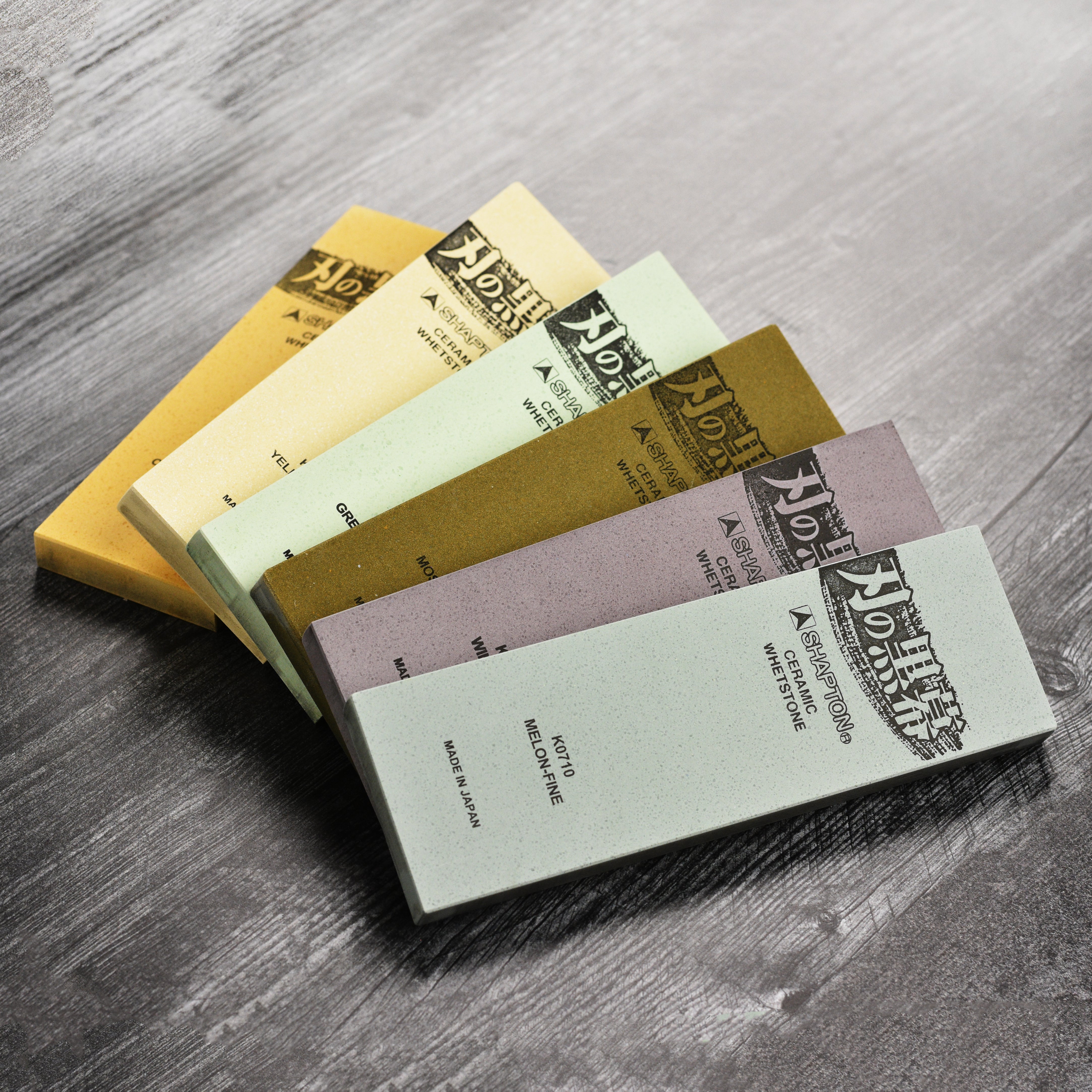 Shapton Kuromaku 8,000 grit sharpening stone with a kitchen knife, highlighting its fine finish.