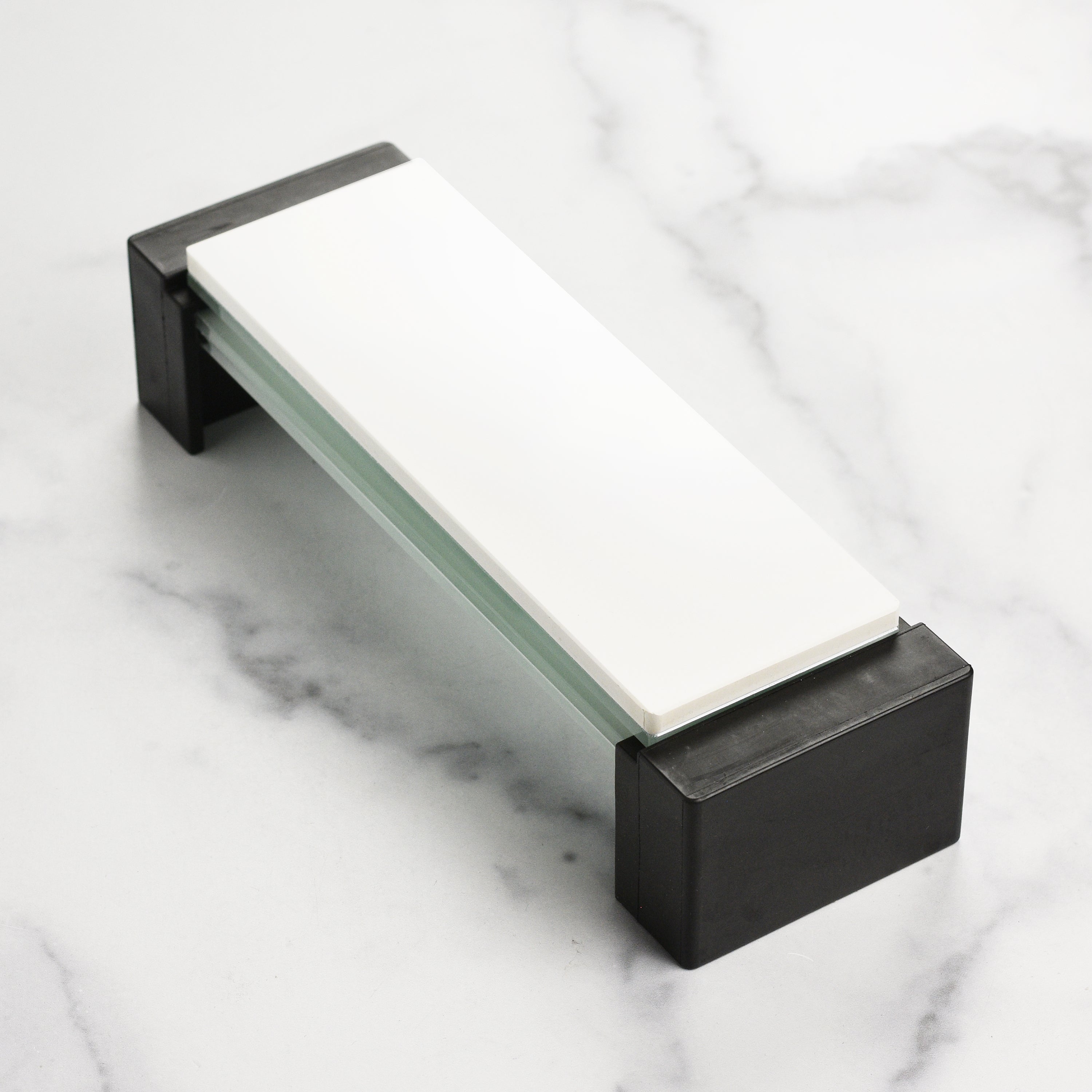 Shapton Glass Stone Holder holding multiple sharpening stones on a kitchen counter