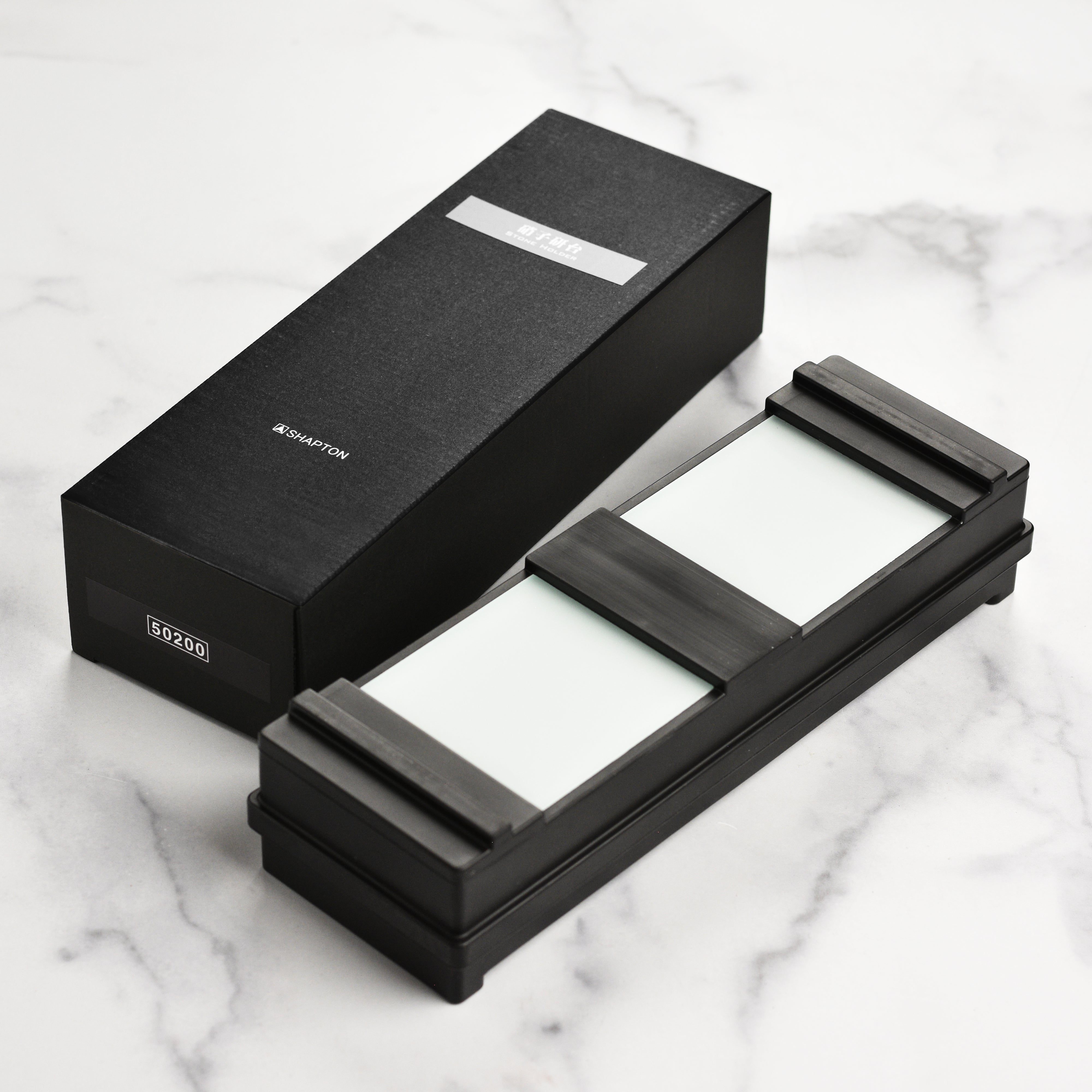 Top-down view of the water stone holder showing textured rubber casing and mounting grooves