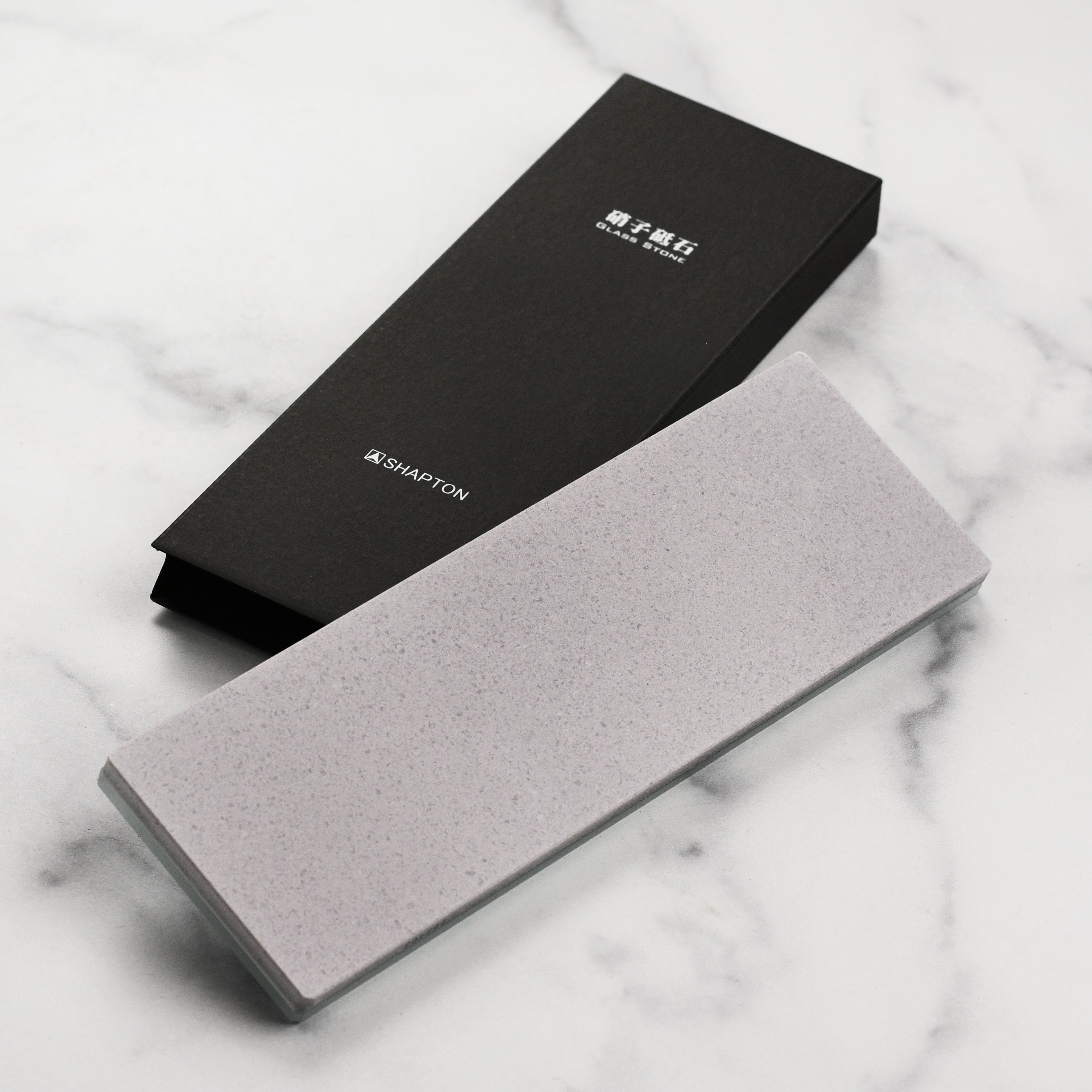 Close-up of the Shapton Glass Stone 220 grit showing the dense ceramic surface ideal for knife repair