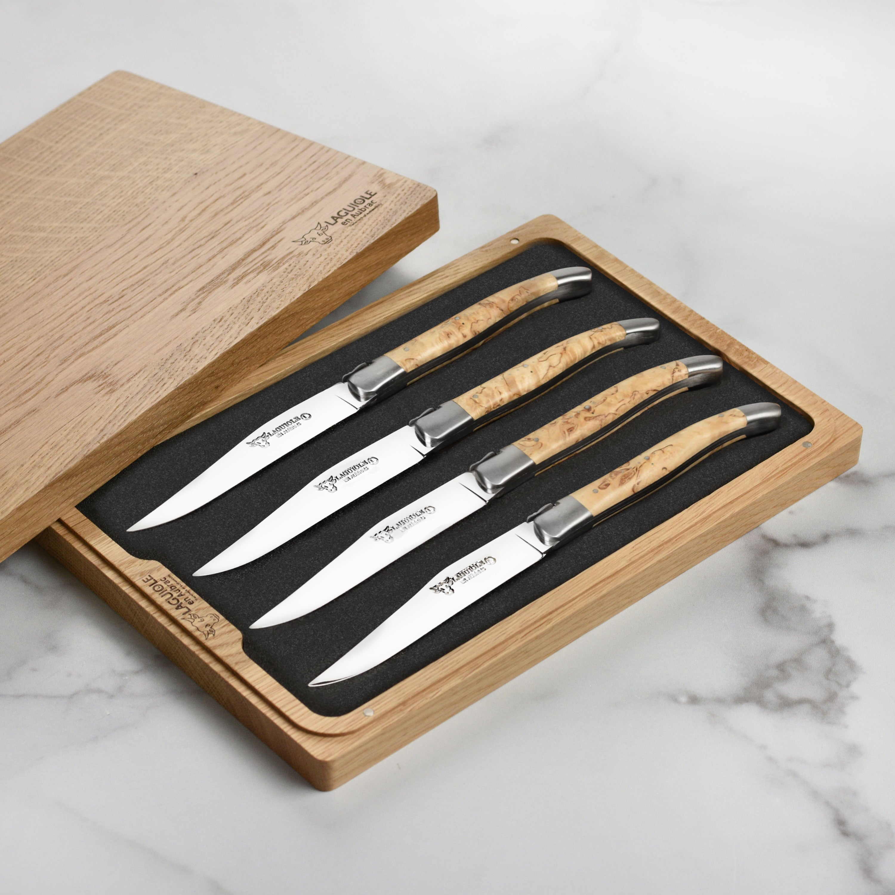Elegant setting featuring Laguiole en Aubrac steak knives ready for a gourmet meal.