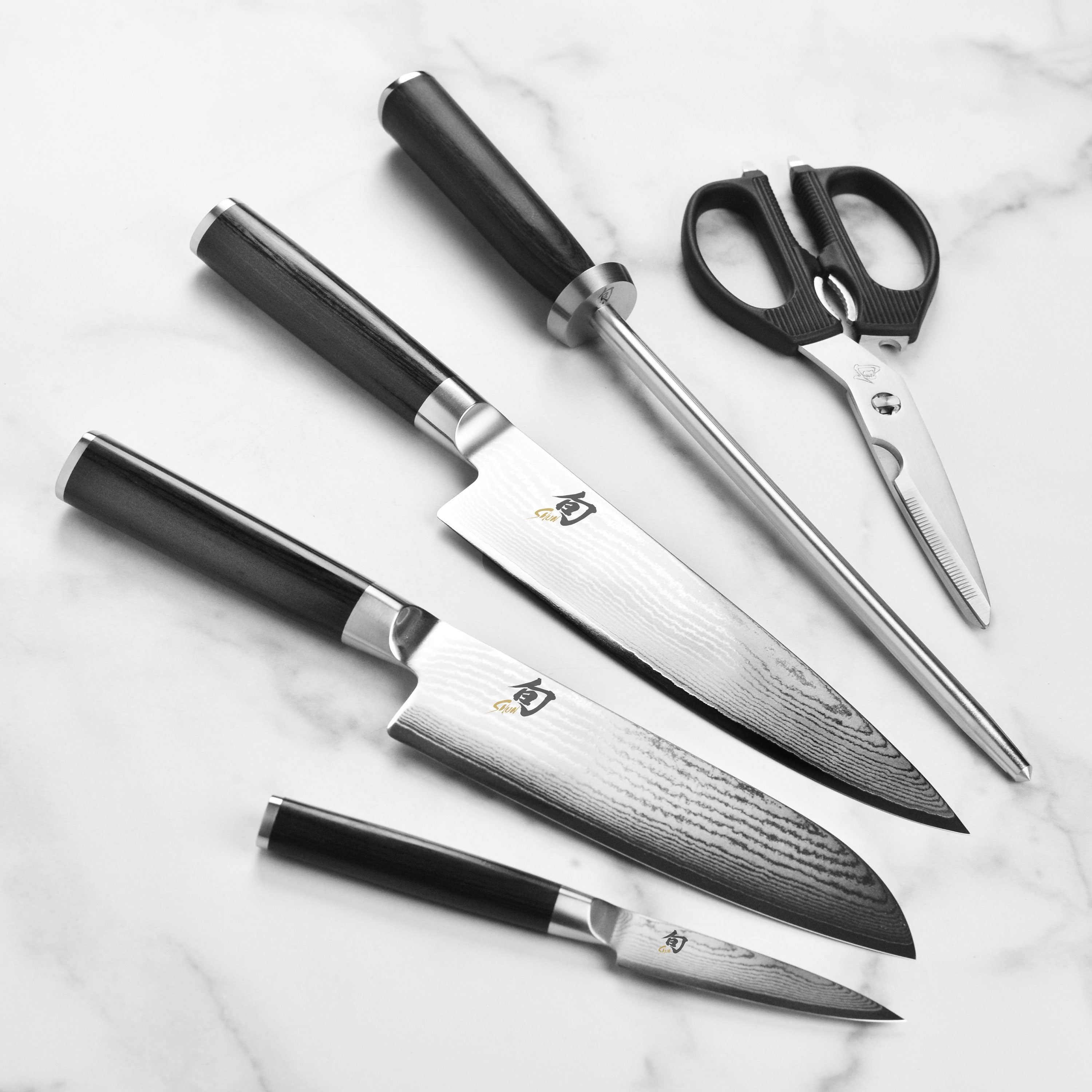 Elegant ebony PakkaWood handle on Japanese kitchen knives, showcasing durability and comfort