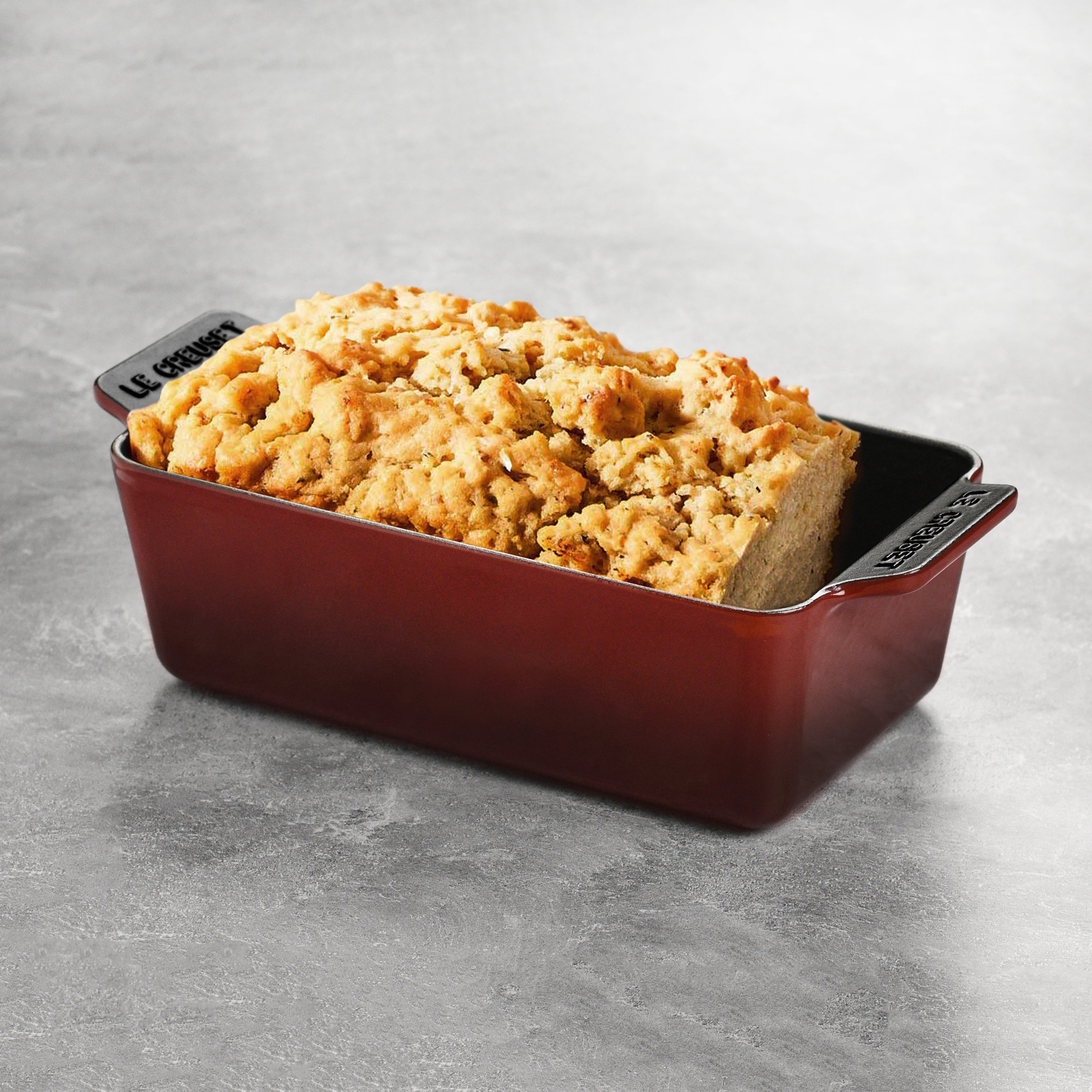 Loaf pan filled with freshly baked bread inside oven — highlighting heat distribution