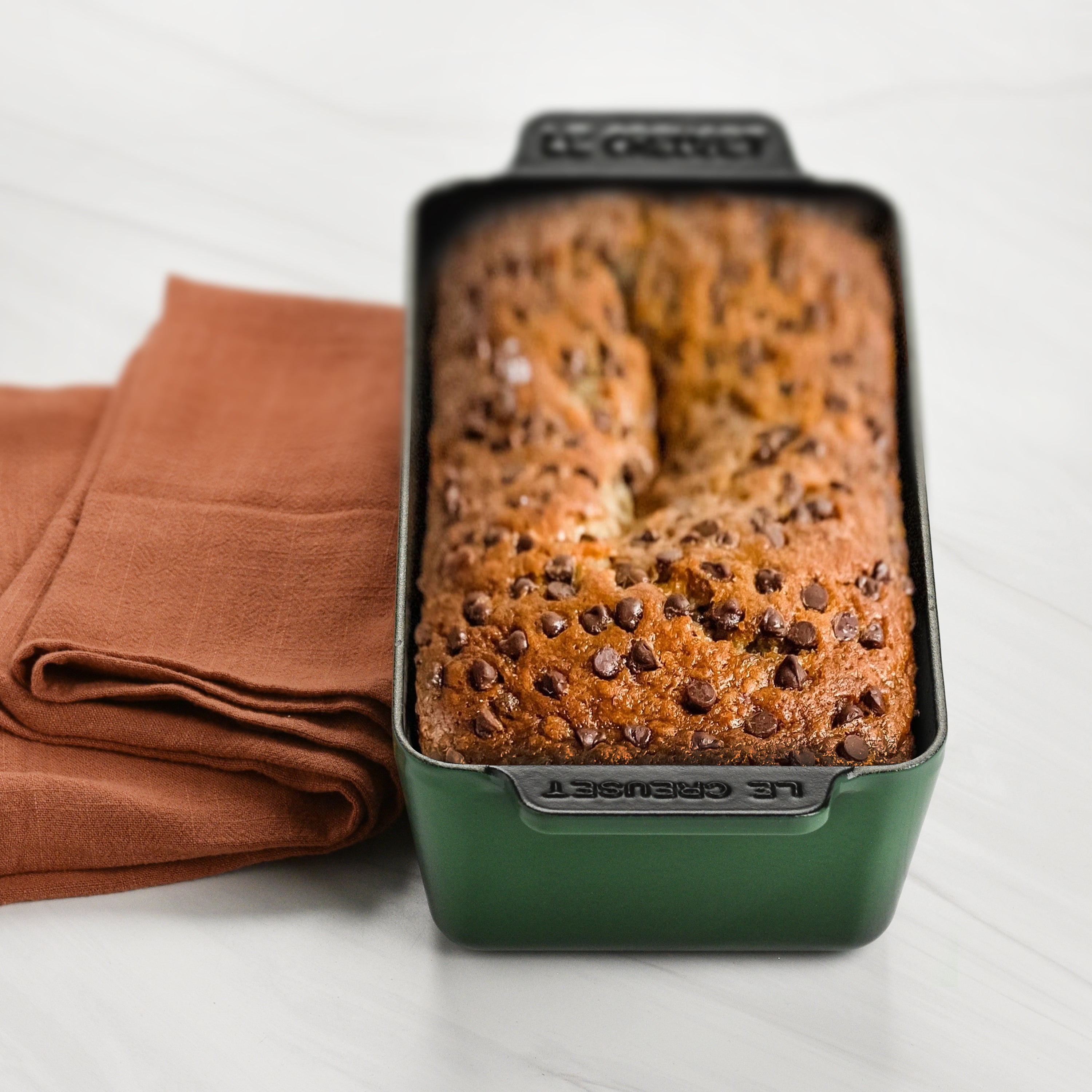 Cast iron bread loaf pan in use, baking bread in a modern kitchen setting