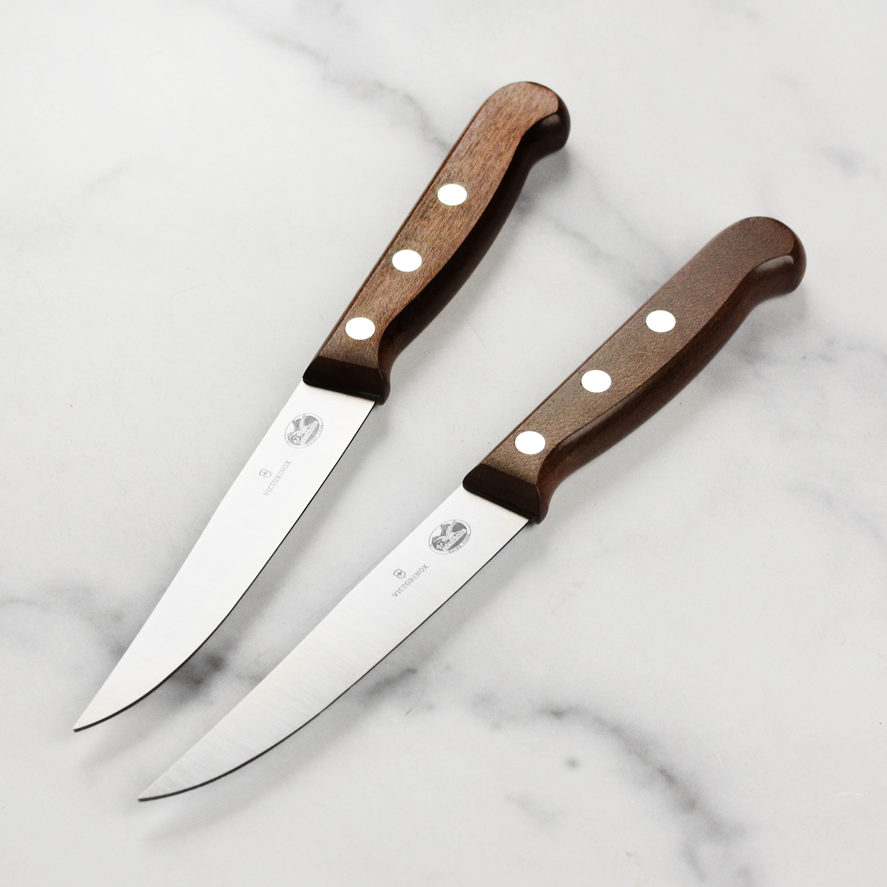 Victorinox steak knife set featuring sharp stainless steel blades and ergonomic maple wood handles.