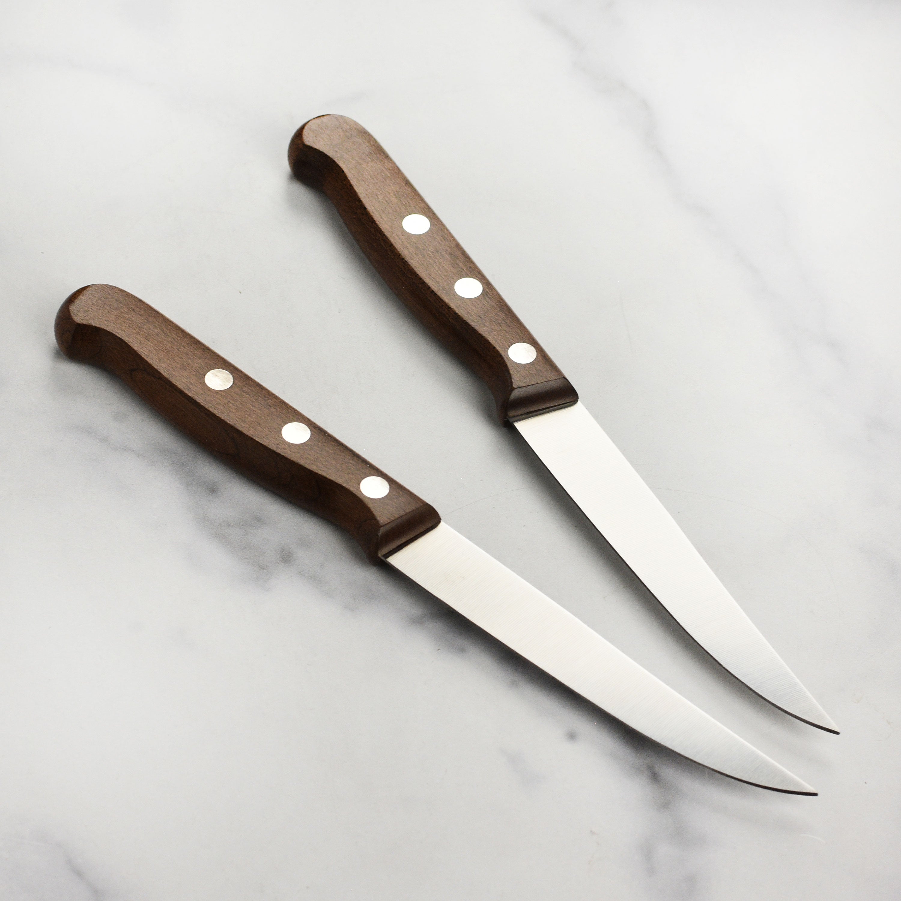 Victorinox steak knife set featuring sharp stainless steel blades and ergonomic maple wood handles.