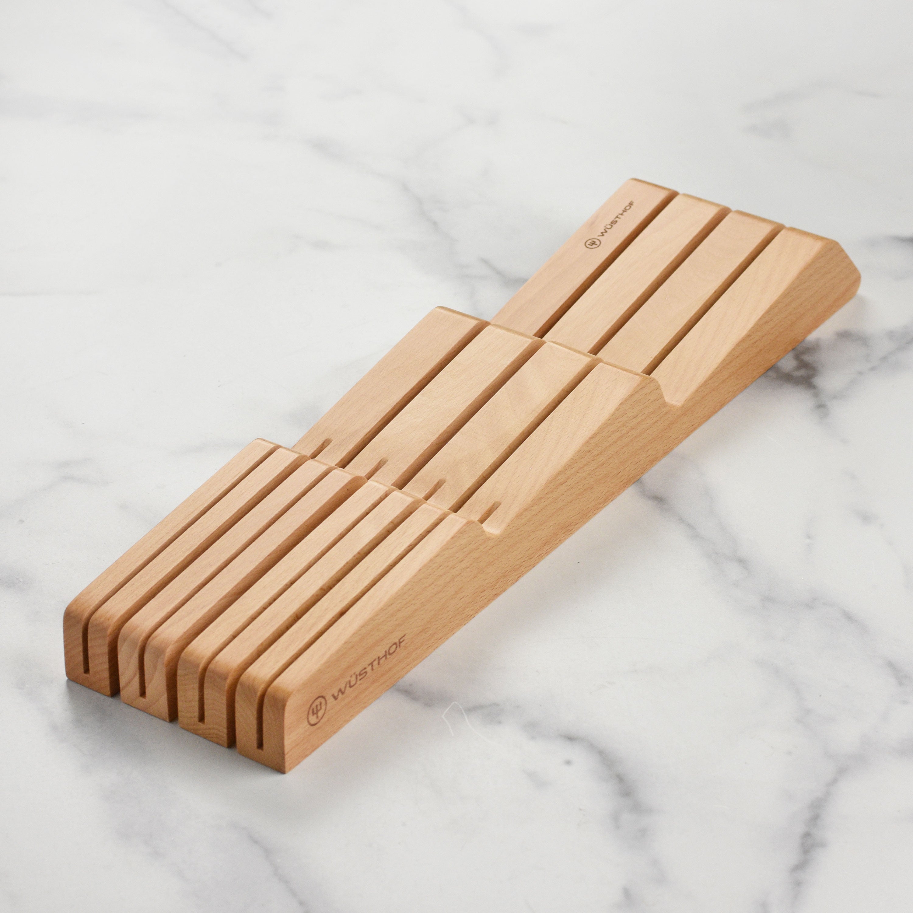 Close-up of premium forged chef knives from the Wusthof Classic set, showcasing the sharp blades