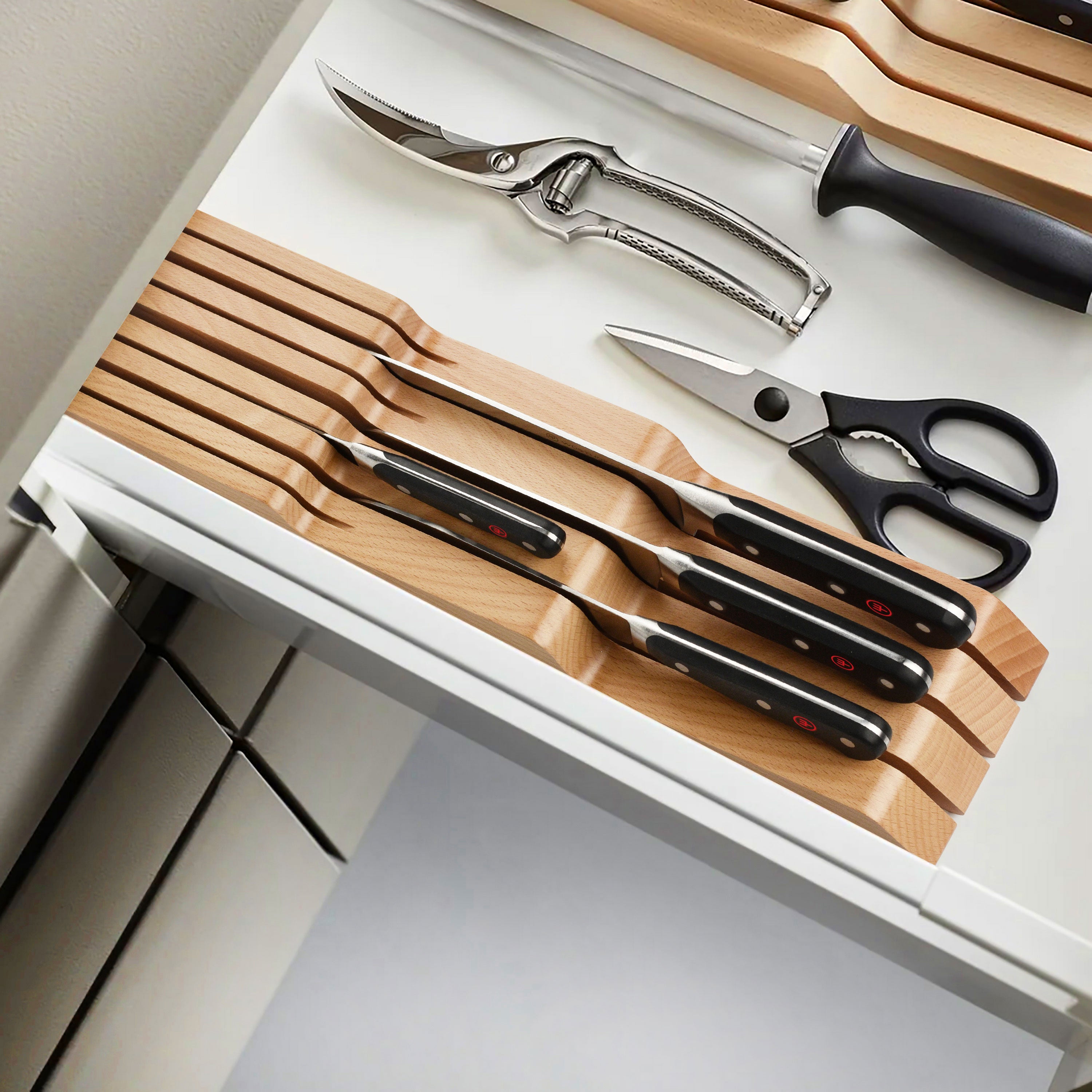 Close-up of premium forged chef knives from the Wusthof Classic set, showcasing the sharp blades