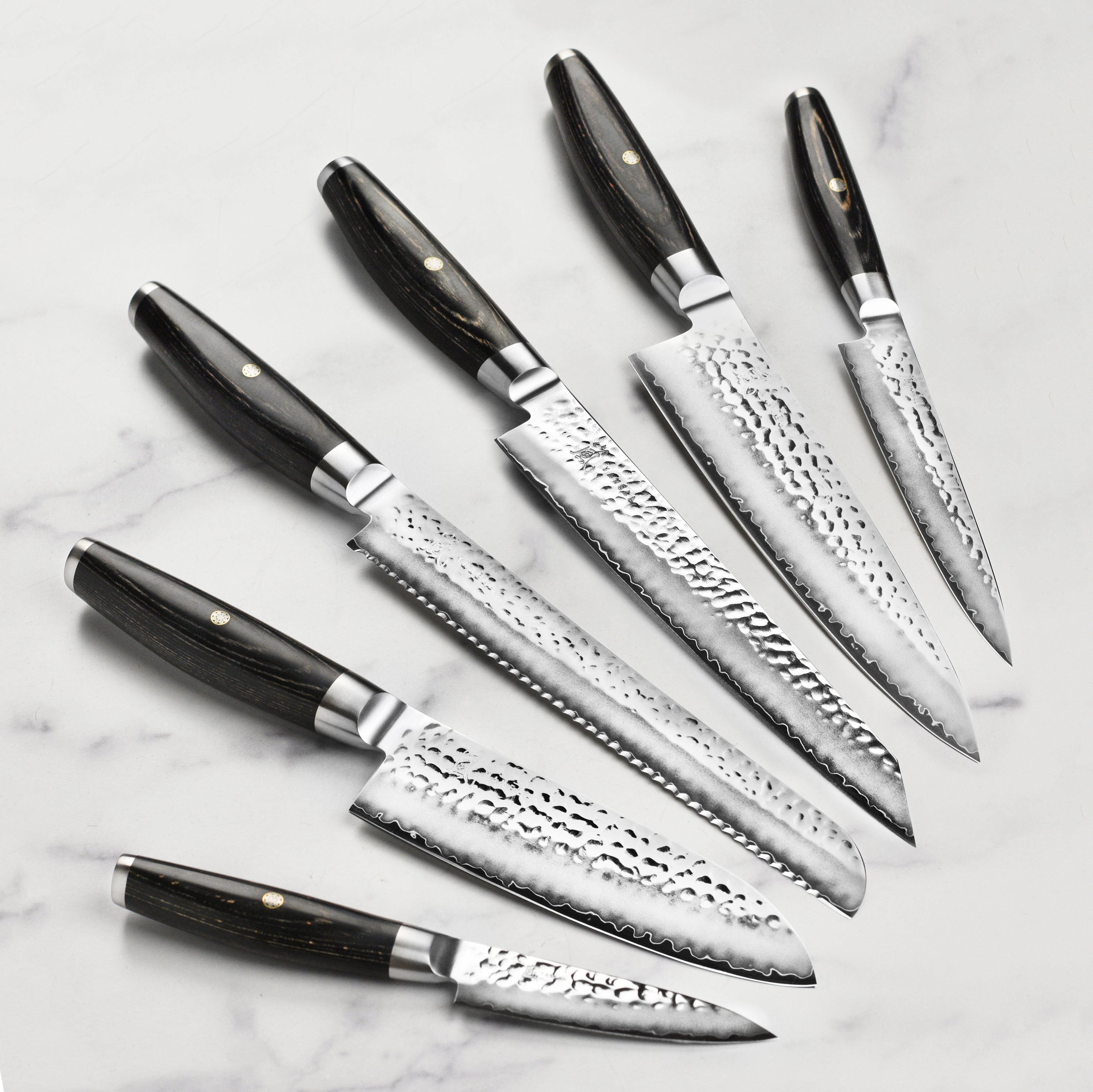 Set of Japanese knives with traditional wave line design and steel end caps