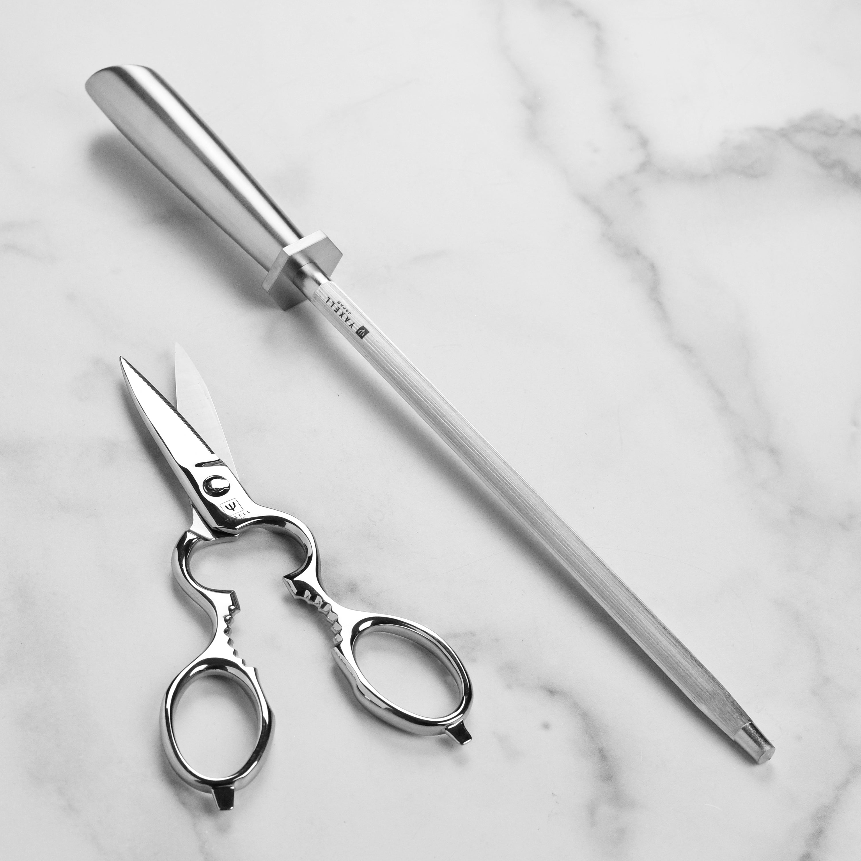 Japanese kitchen knife set displayed on a wooden countertop with a cutting board