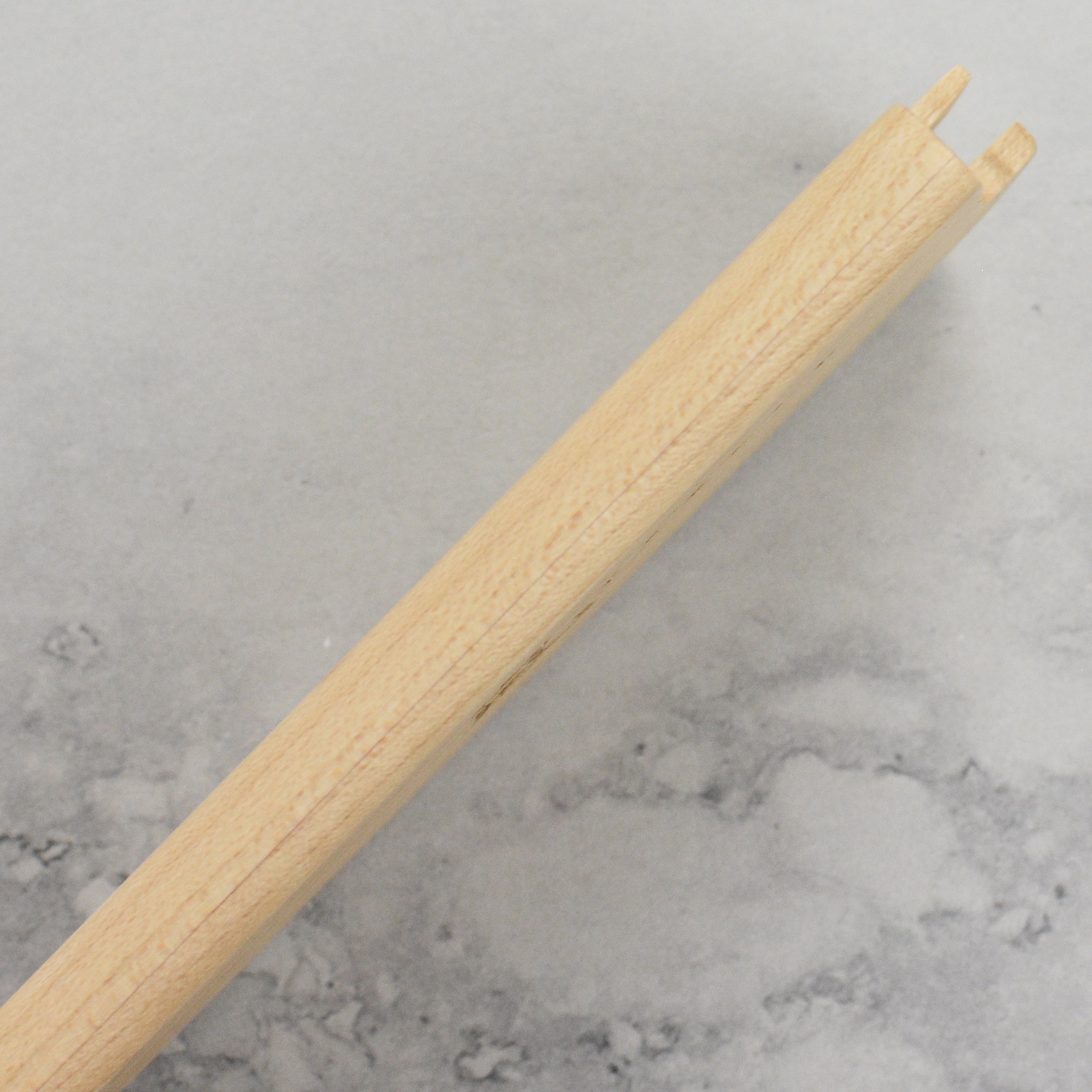 Yaxell wooden knife sheath resting on a kitchen countertop, highlighting its elegant design.