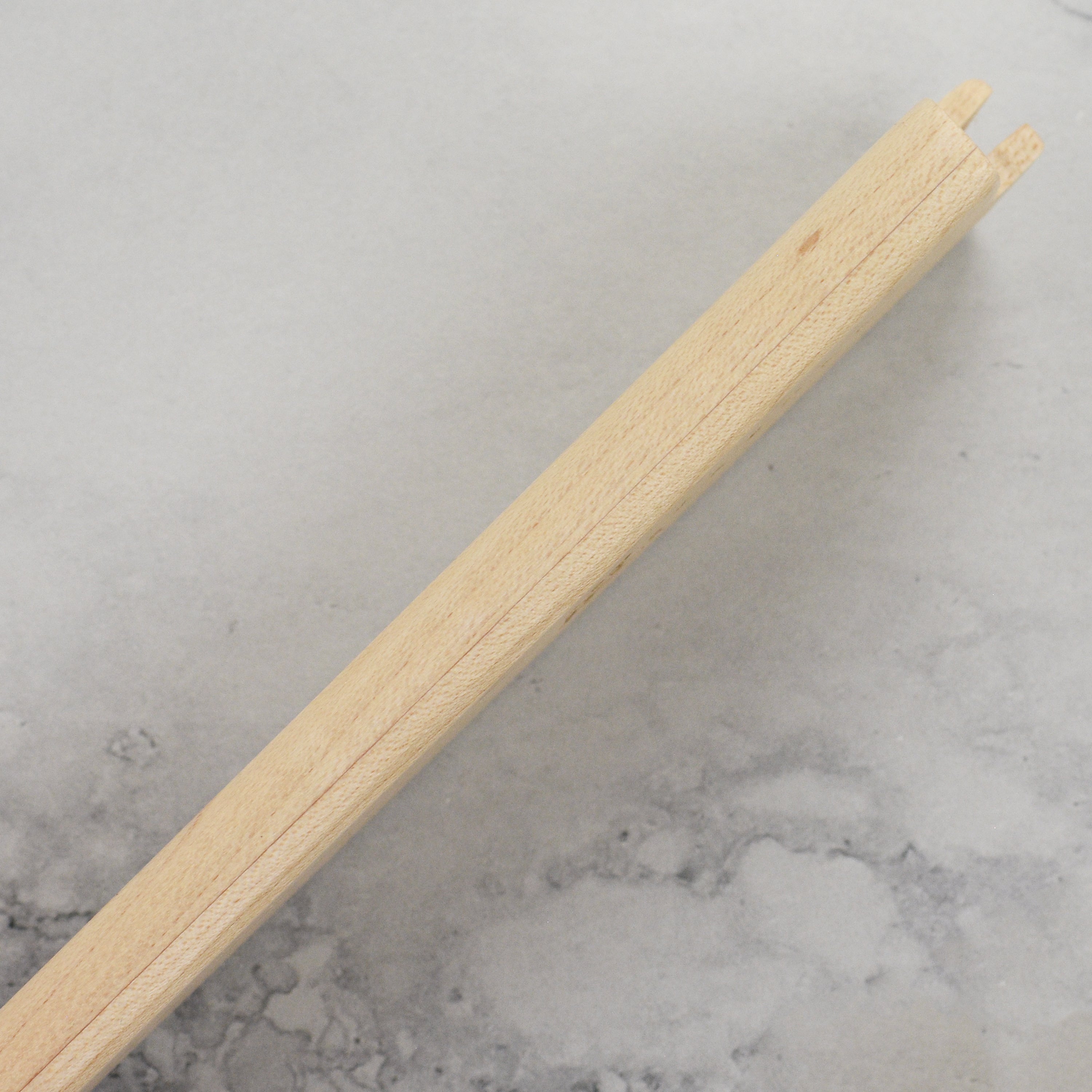Yaxell knife sheath displayed on a wooden kitchen counter with other kitchen tools.