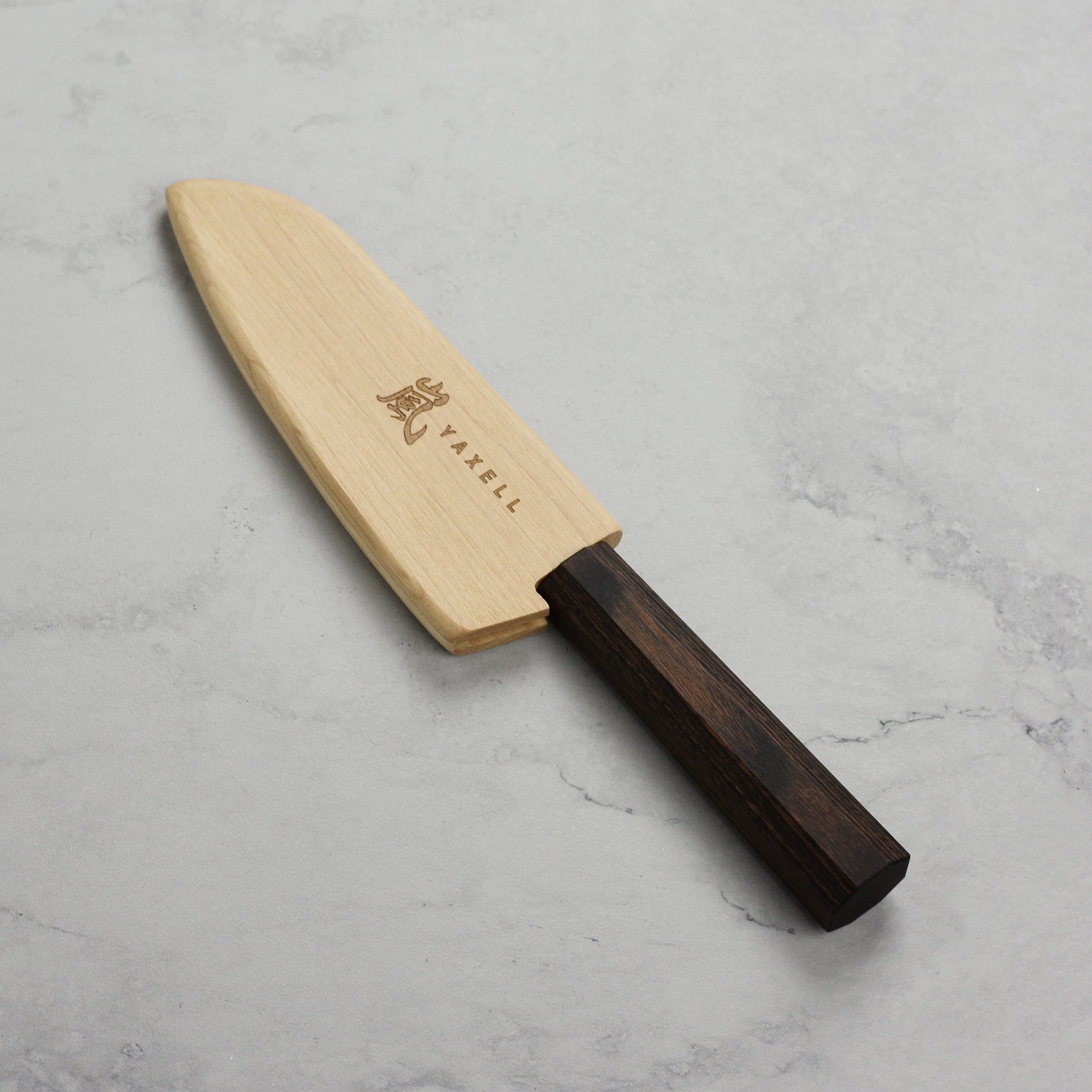 Side view of the wooden knife sheath holding a Santoku knife, highlighting its traditional design.