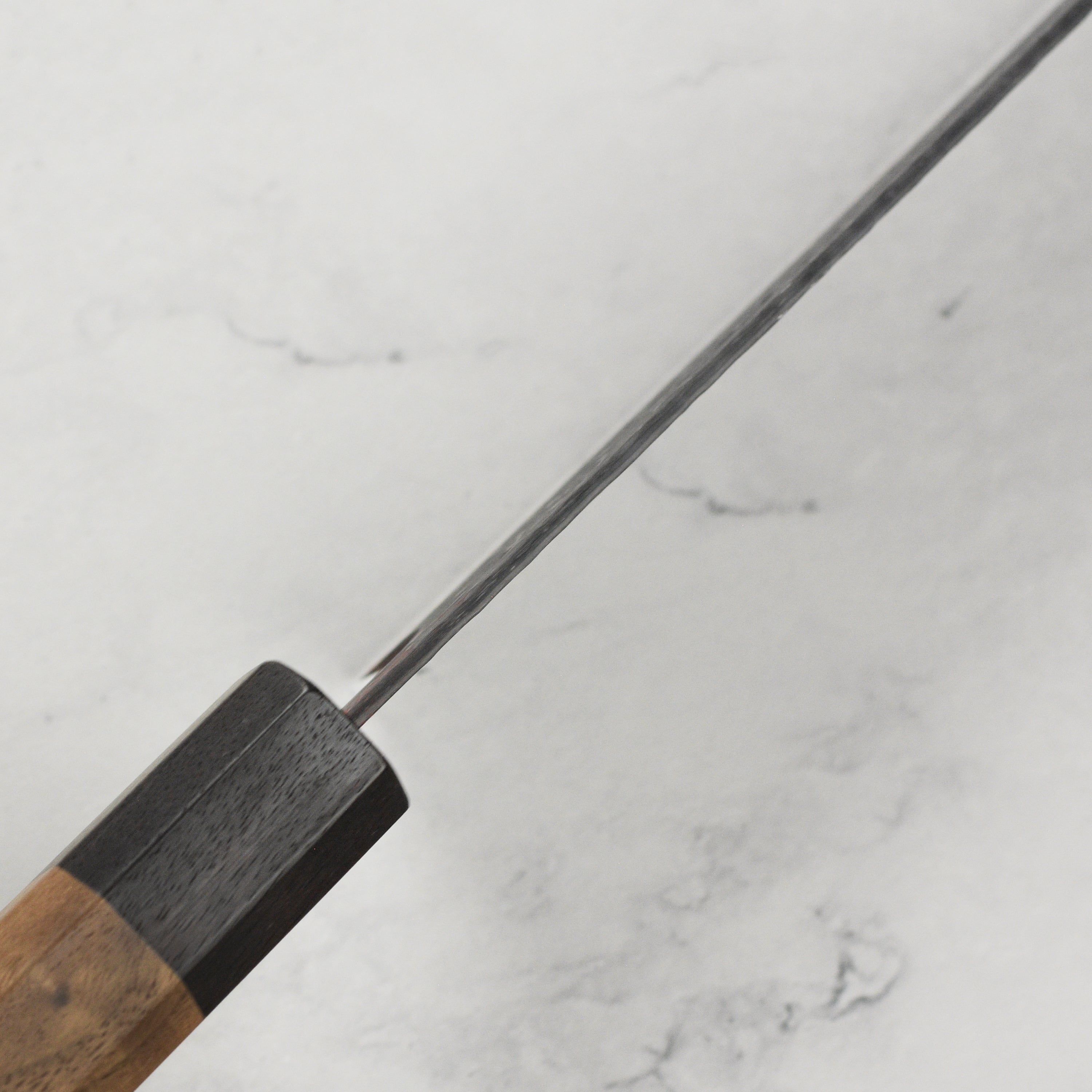 Close-up of the sharp edge on a gyuto knife used for slicing vegetables