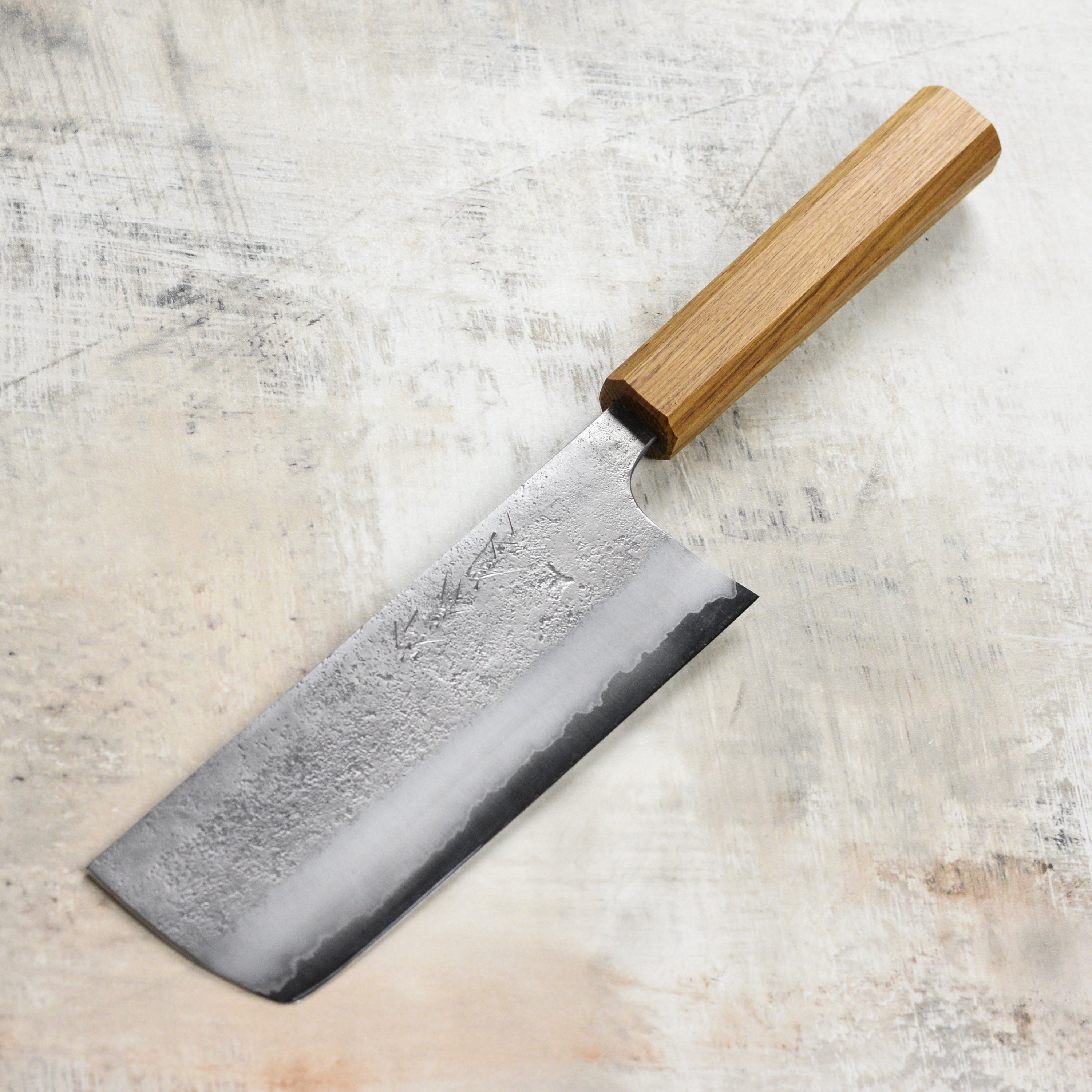 Top view of the Matsubara Aogami #2 Nashiji stainless clad nakiri highlighting its blade craftsmanship