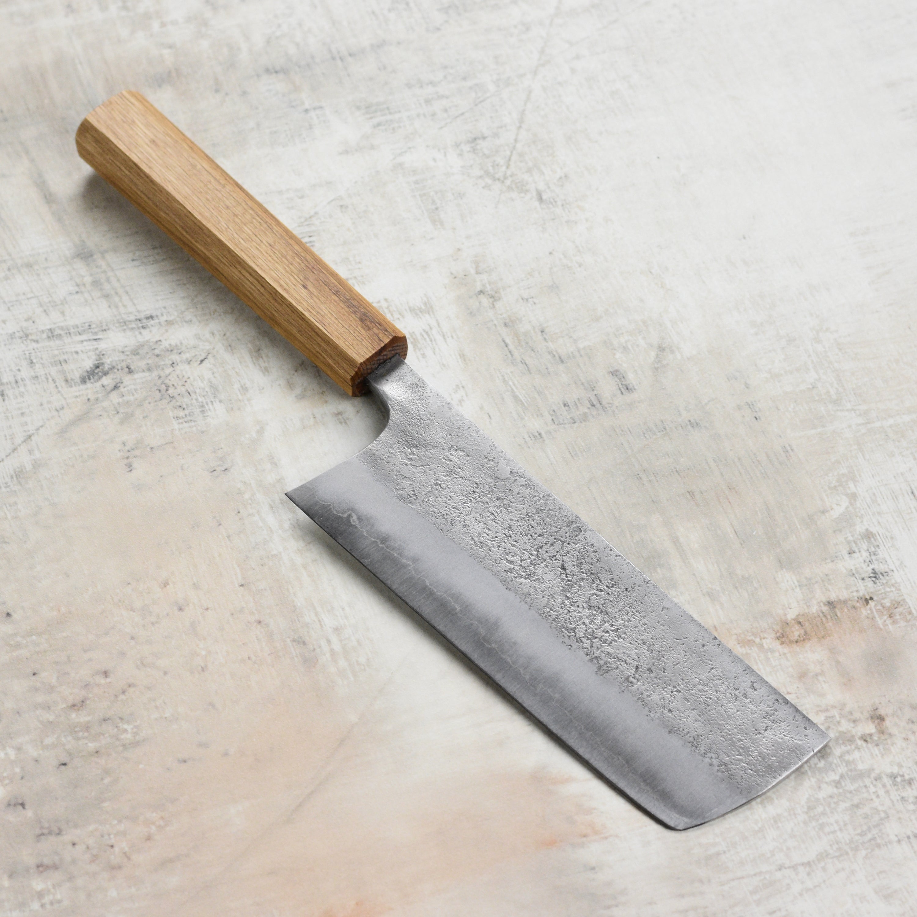 Chef slicing vegetables with the high-quality Japanese kitchen knife in a professional kitchen