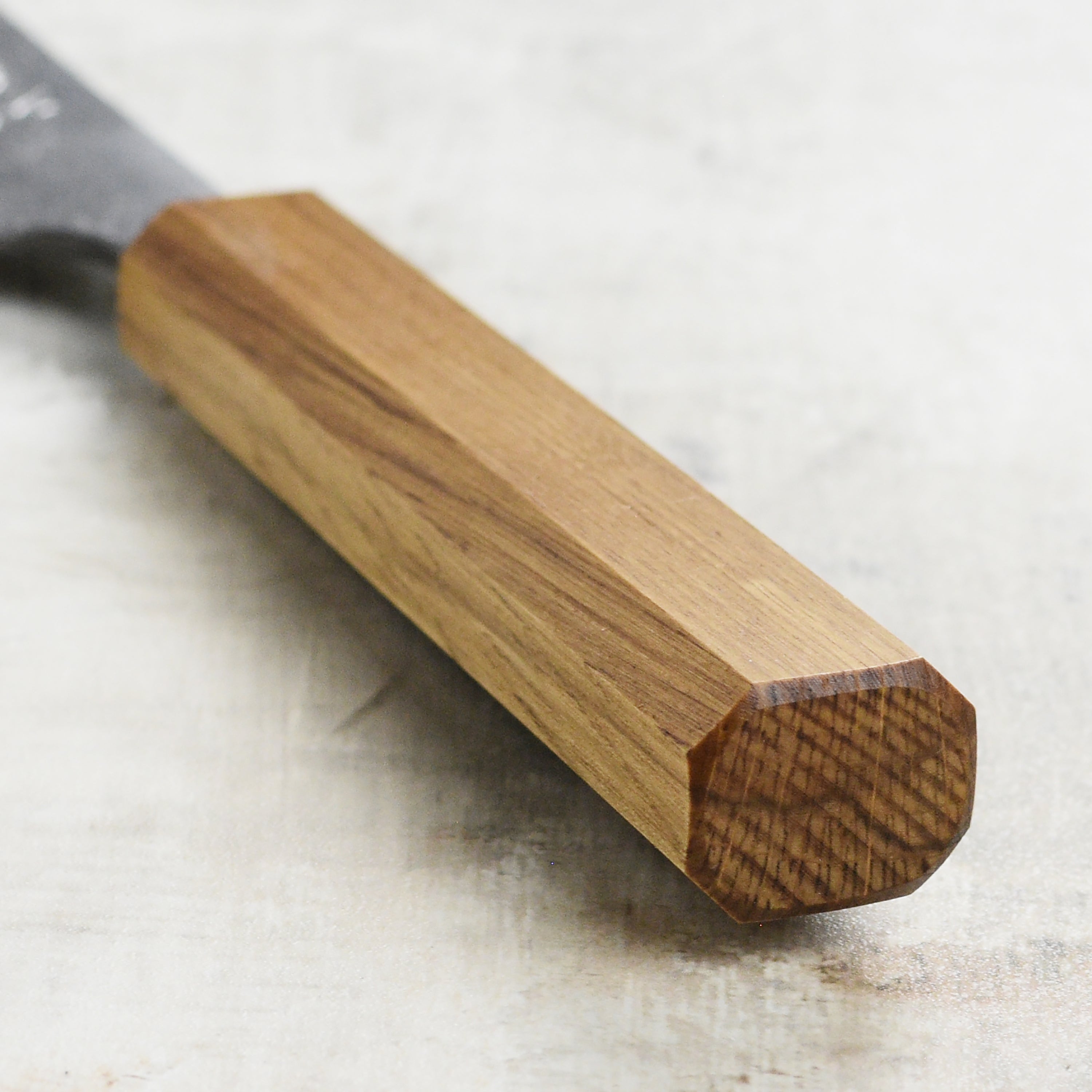 Chef slicing vegetables with the high-quality Japanese kitchen knife in a professional kitchen